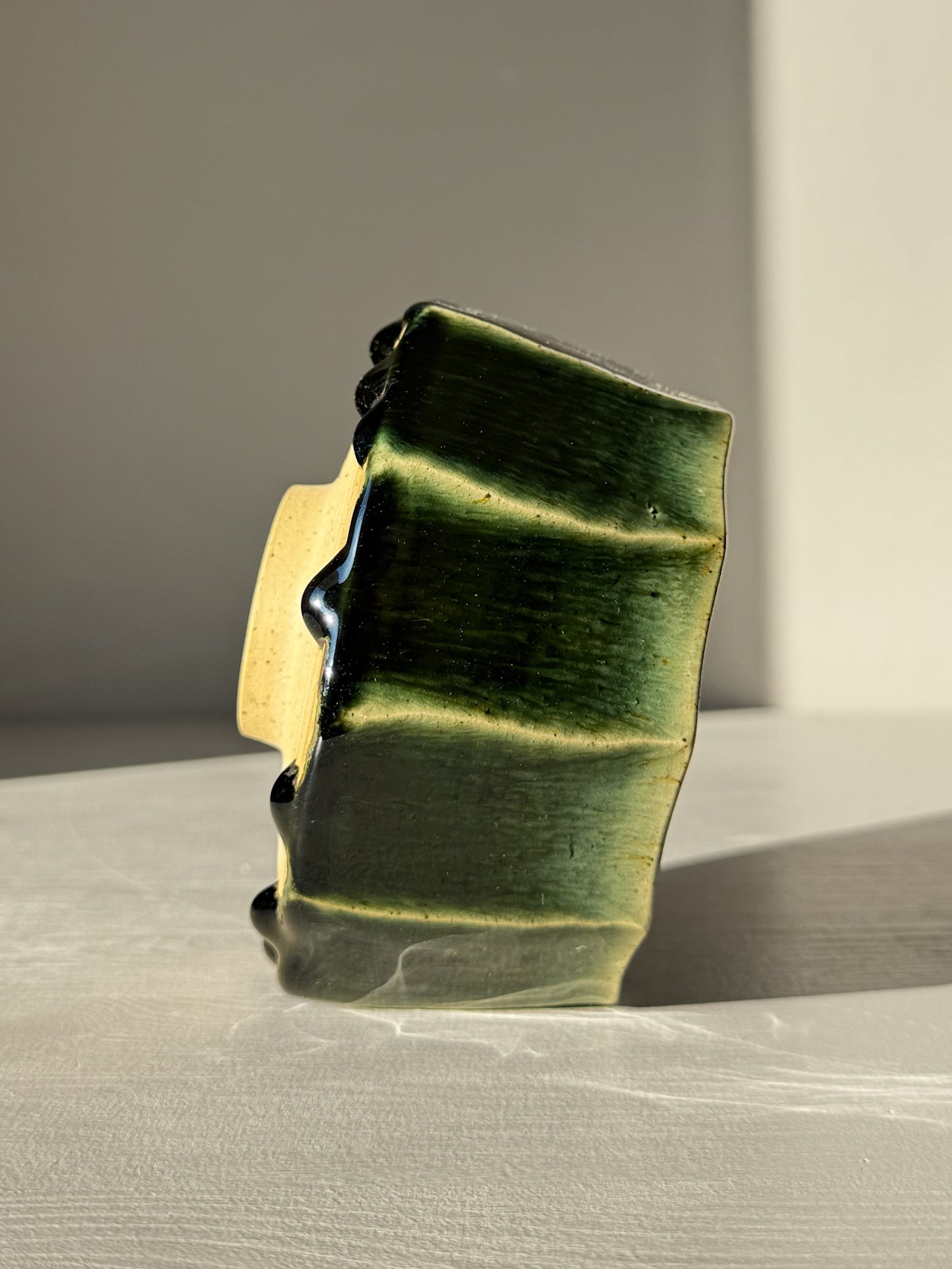 Side view of the Faceted Matcha Bowl - Hinoki #03 with deep green glaze and hand-carved facets.