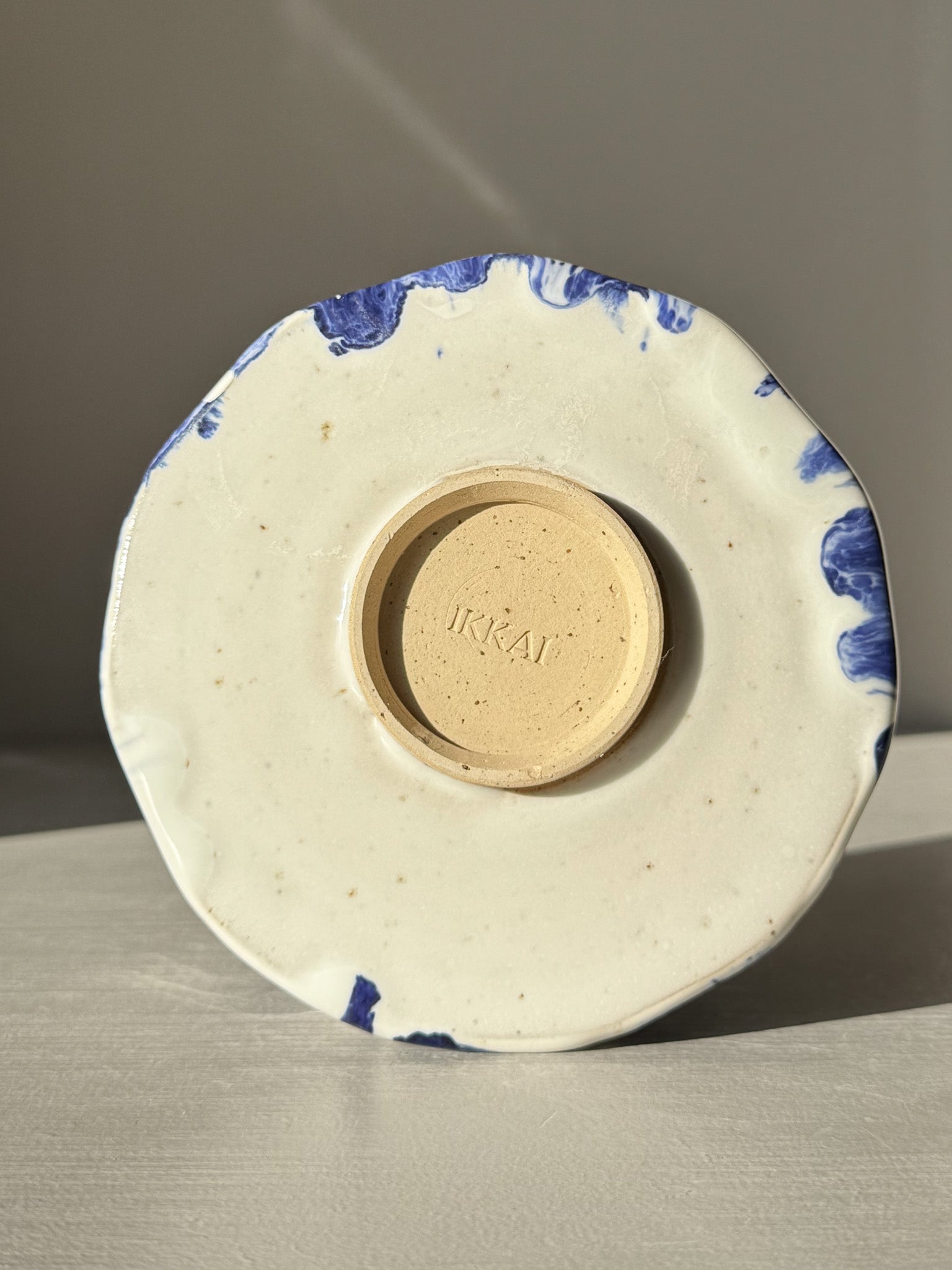 Base view of Faceted Matcha Bowl with Spout – White & Blue #01 showing artisan detail and cobalt blue accents.