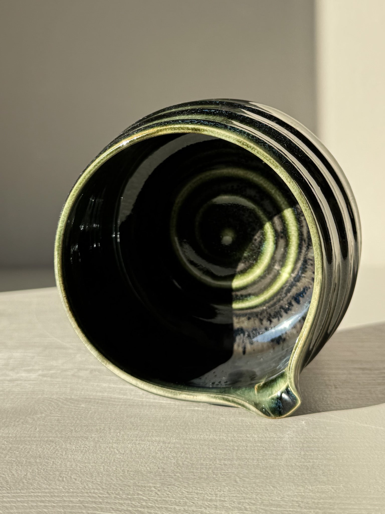 Top view of a Textured Matcha Bowl Spout - Hinoki #04 with glossy green glaze and subtle ridges.