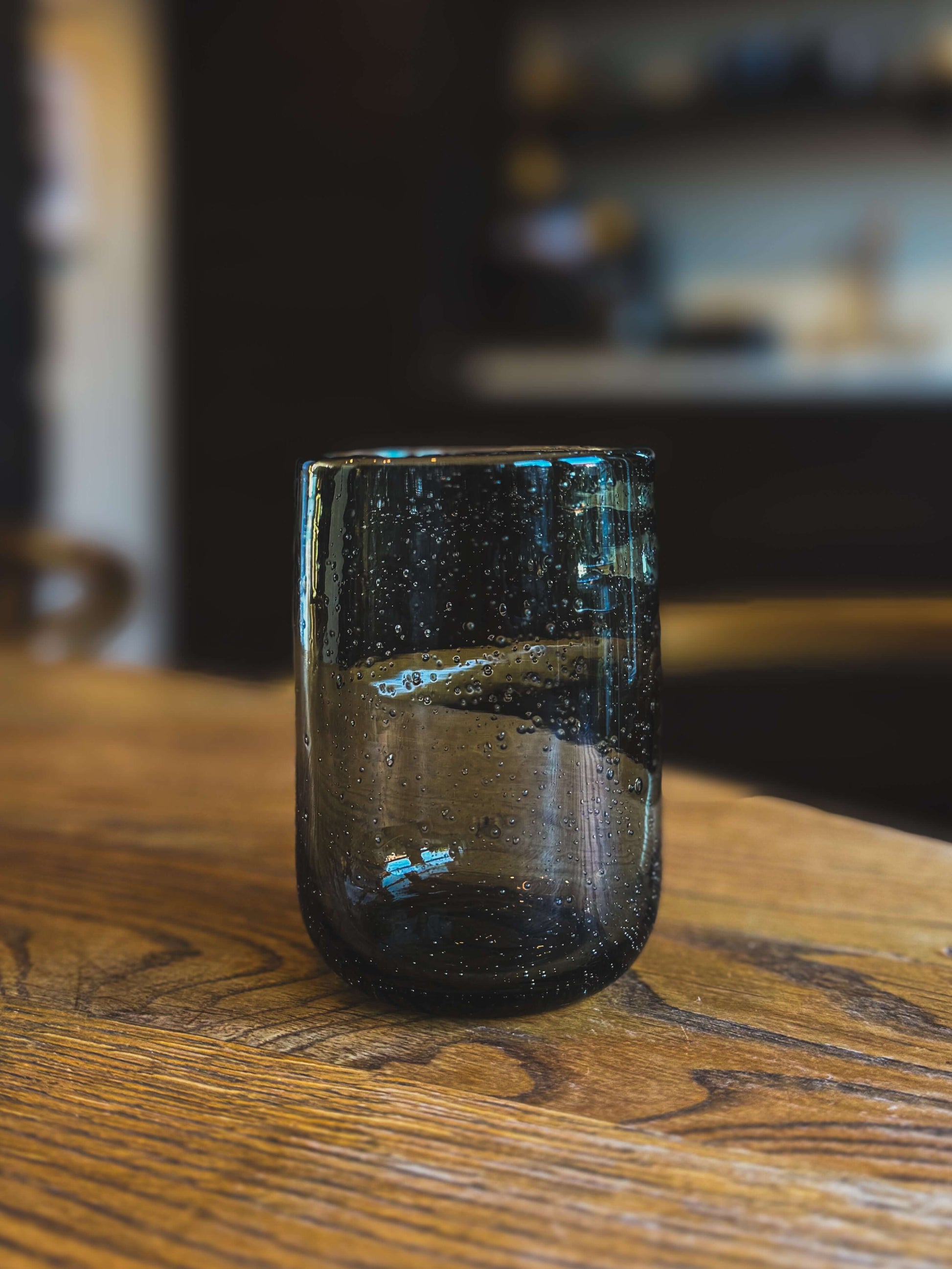 Grey Water Glass – Natural Tumbler with handmade ceramic charm, featuring a unique, timeless design and soft grey-blue tone.
