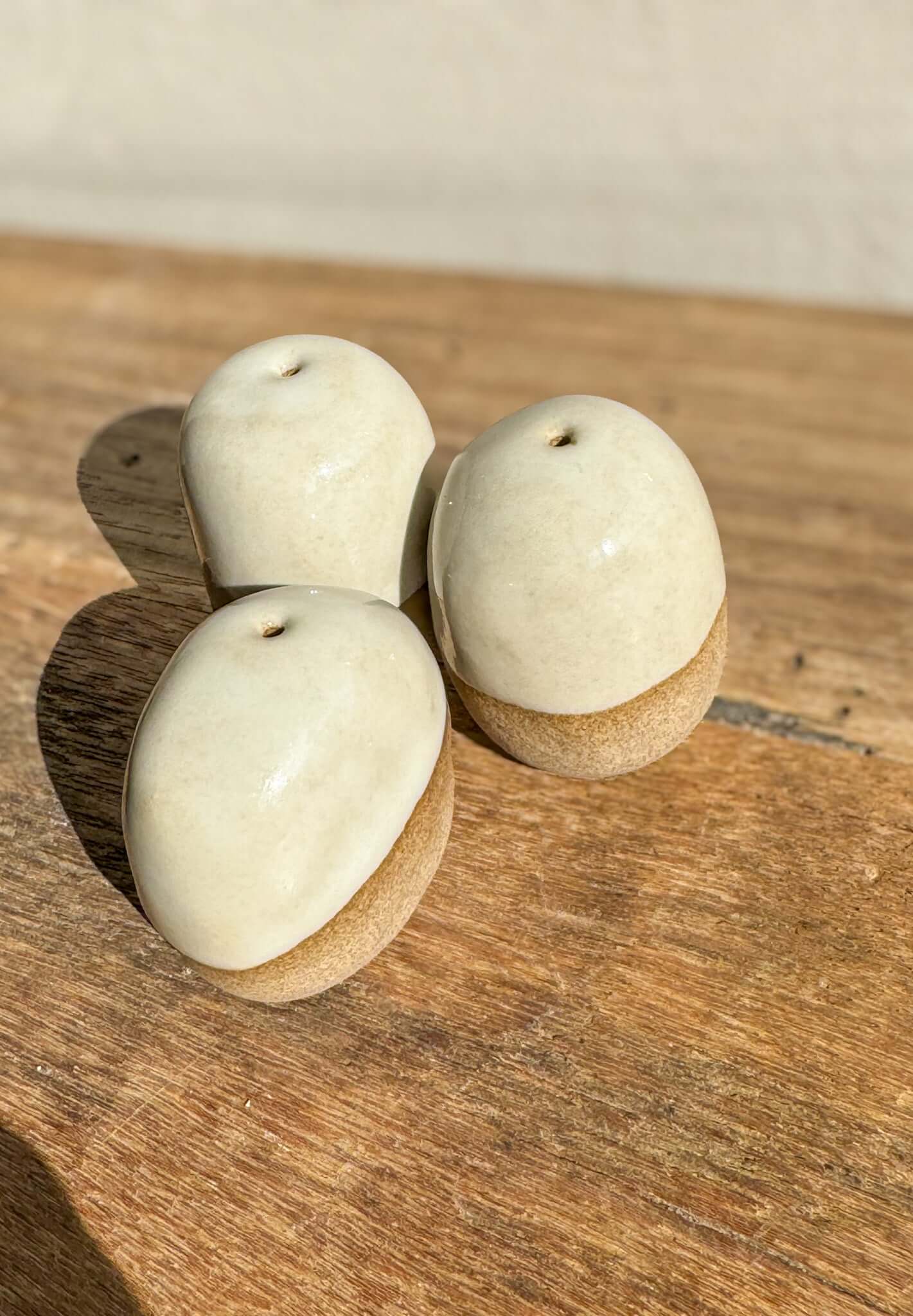 Handmade ceramic Incense Holder Pebbles set on wooden surface, shaped like smooth river stones