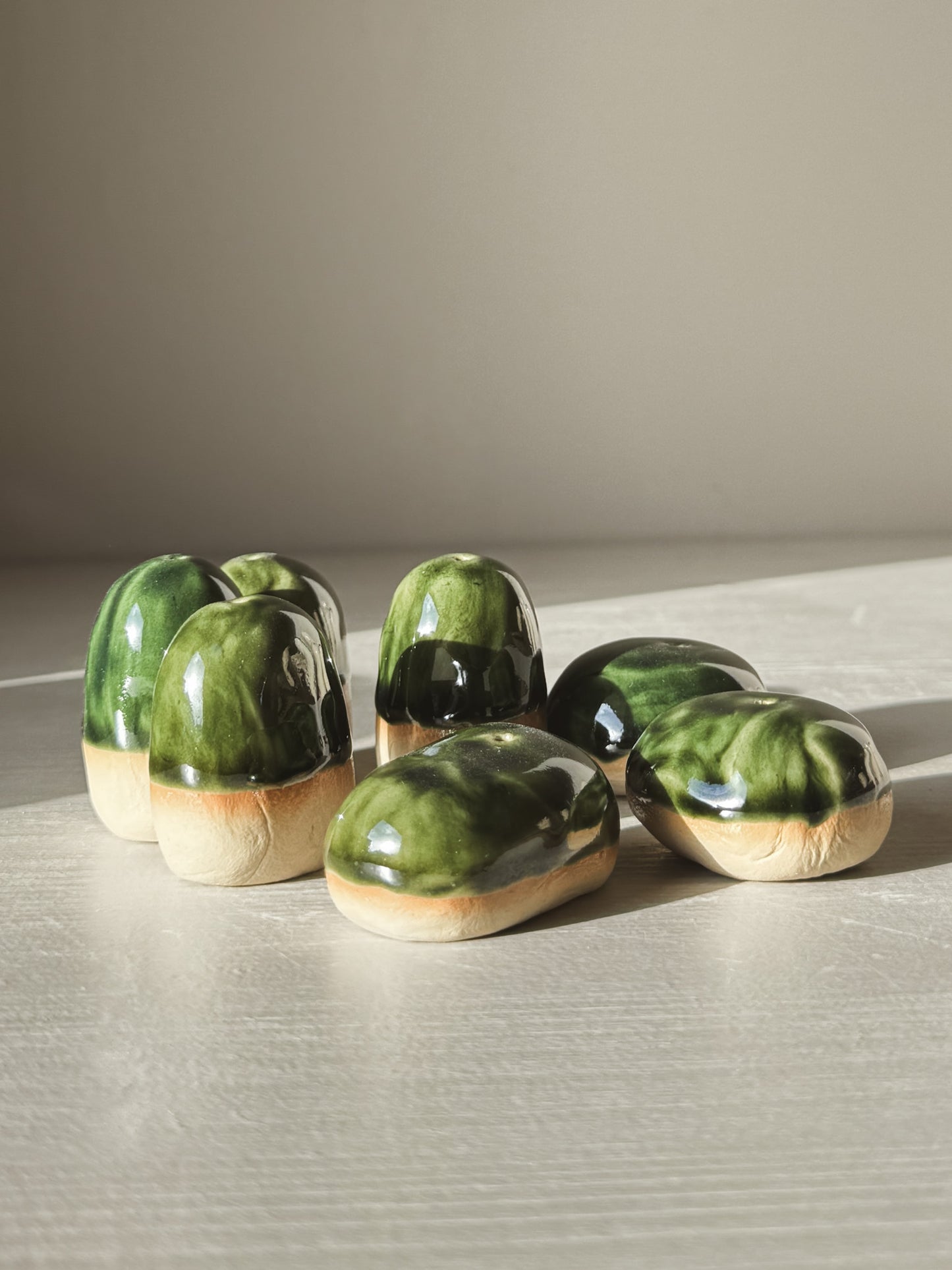 Hand-formed Incense Holder Pebbles in natural glazed stoneware with a glossy finish, designed to hold a single incense stick.