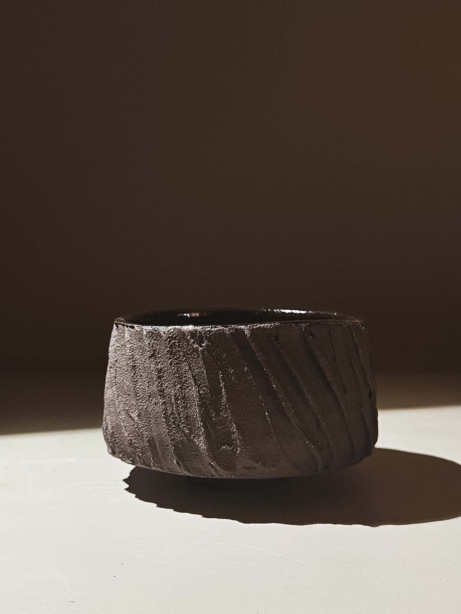 Kuro Matcha Bowl #06 with earthy textured dark brown slip and glossy interior, inspired by volcanic stone.