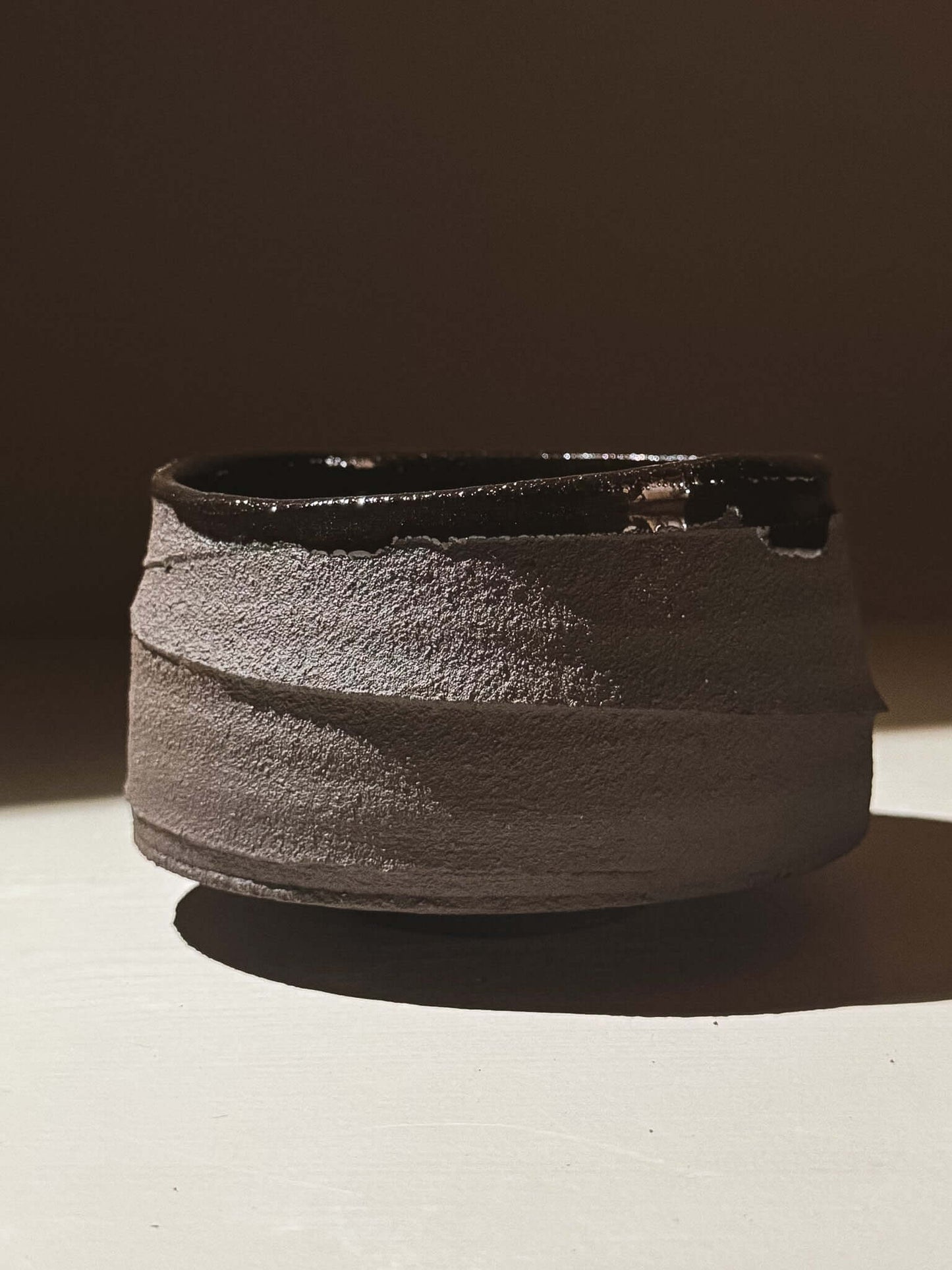 Kuro Matcha Bowl #10 with textured dark brown exterior and glossy interior inspired by volcanic stone and earthy textures.