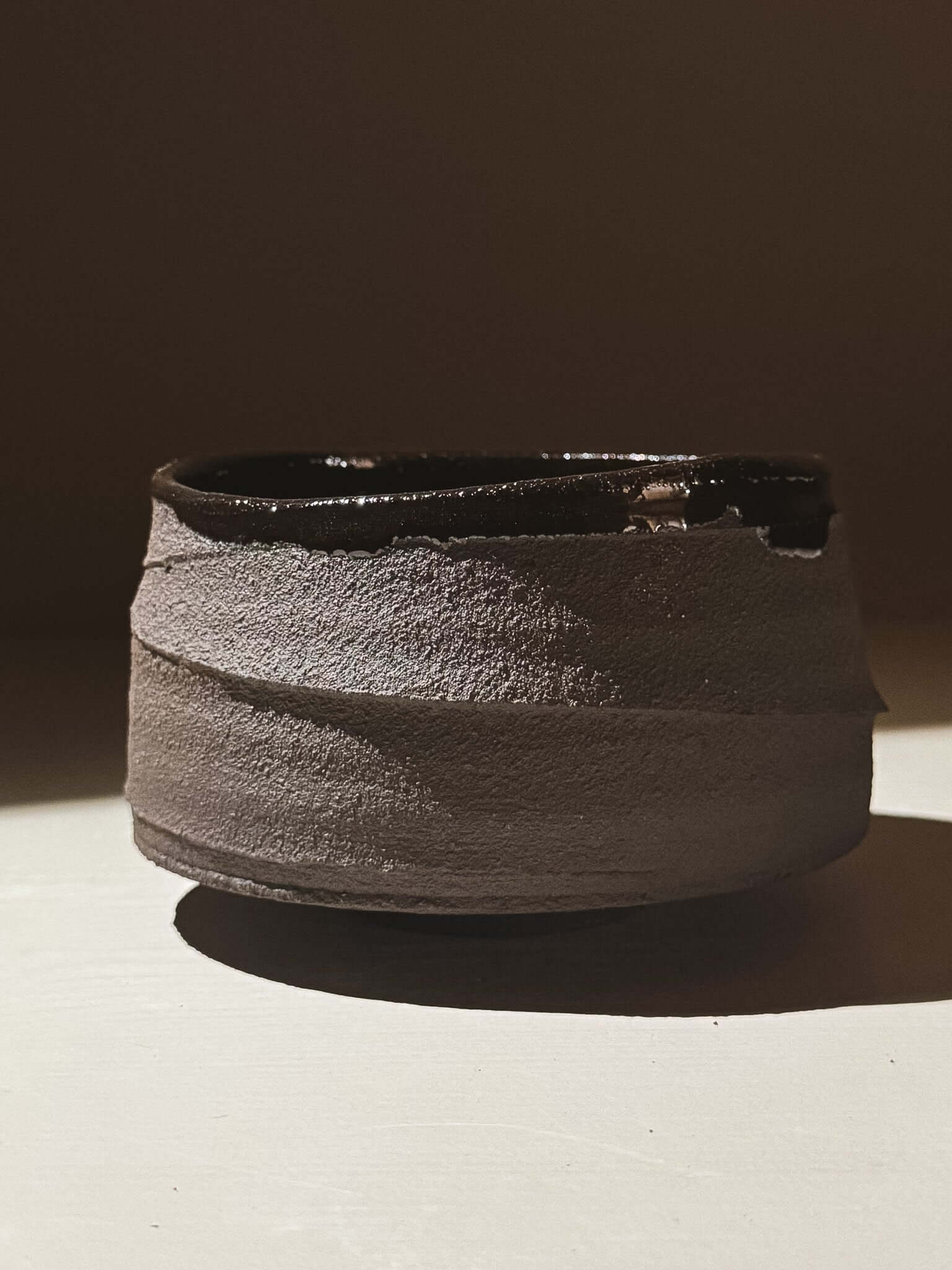 Kuro Matcha Bowl #10 with textured dark brown exterior and glossy interior inspired by volcanic stone and earthy textures.