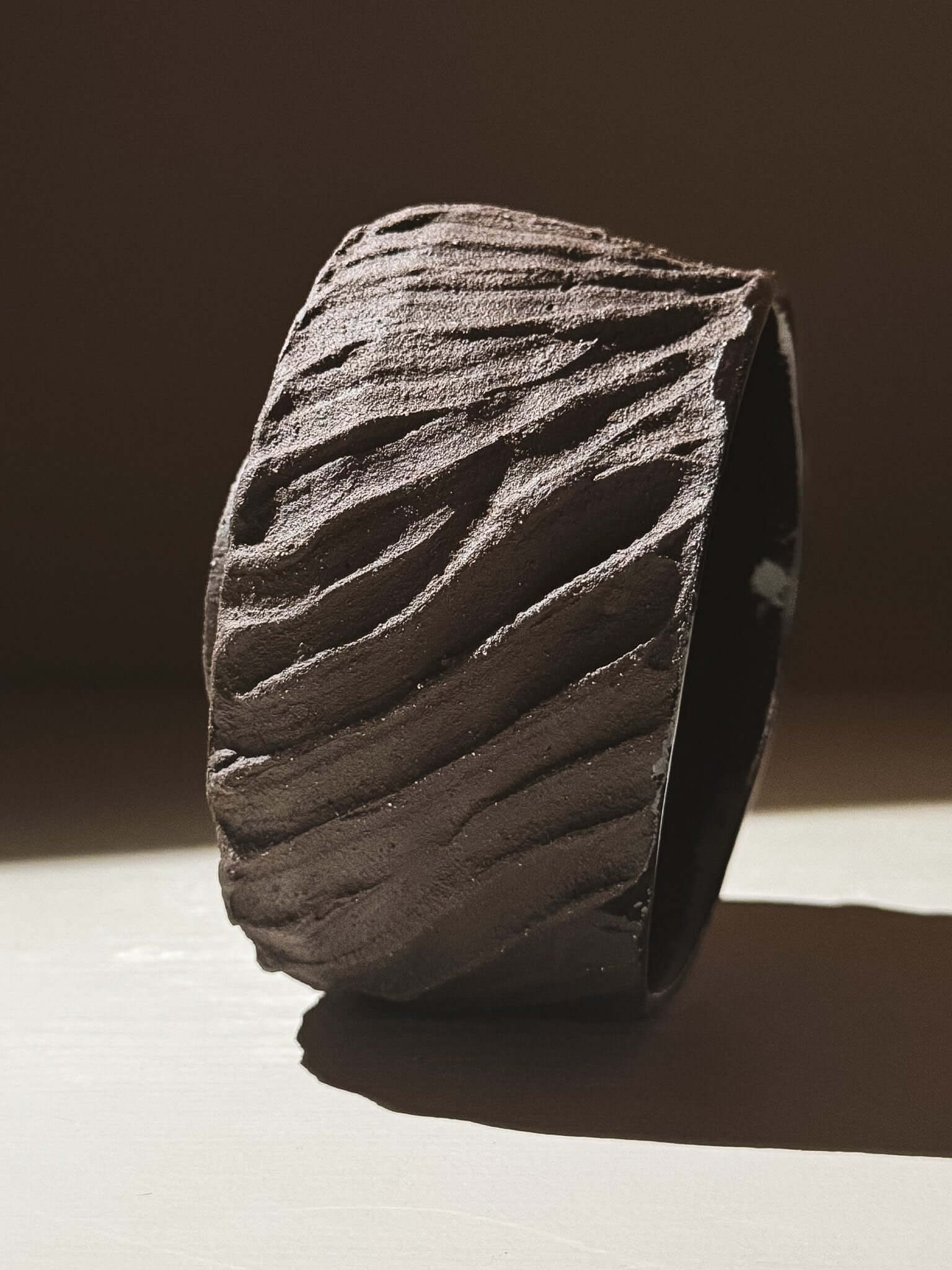 Kuro Matcha Bowl #04 with textured dark brown slip and glossy interior, inspired by volcanic stone for a natural, earthy look.