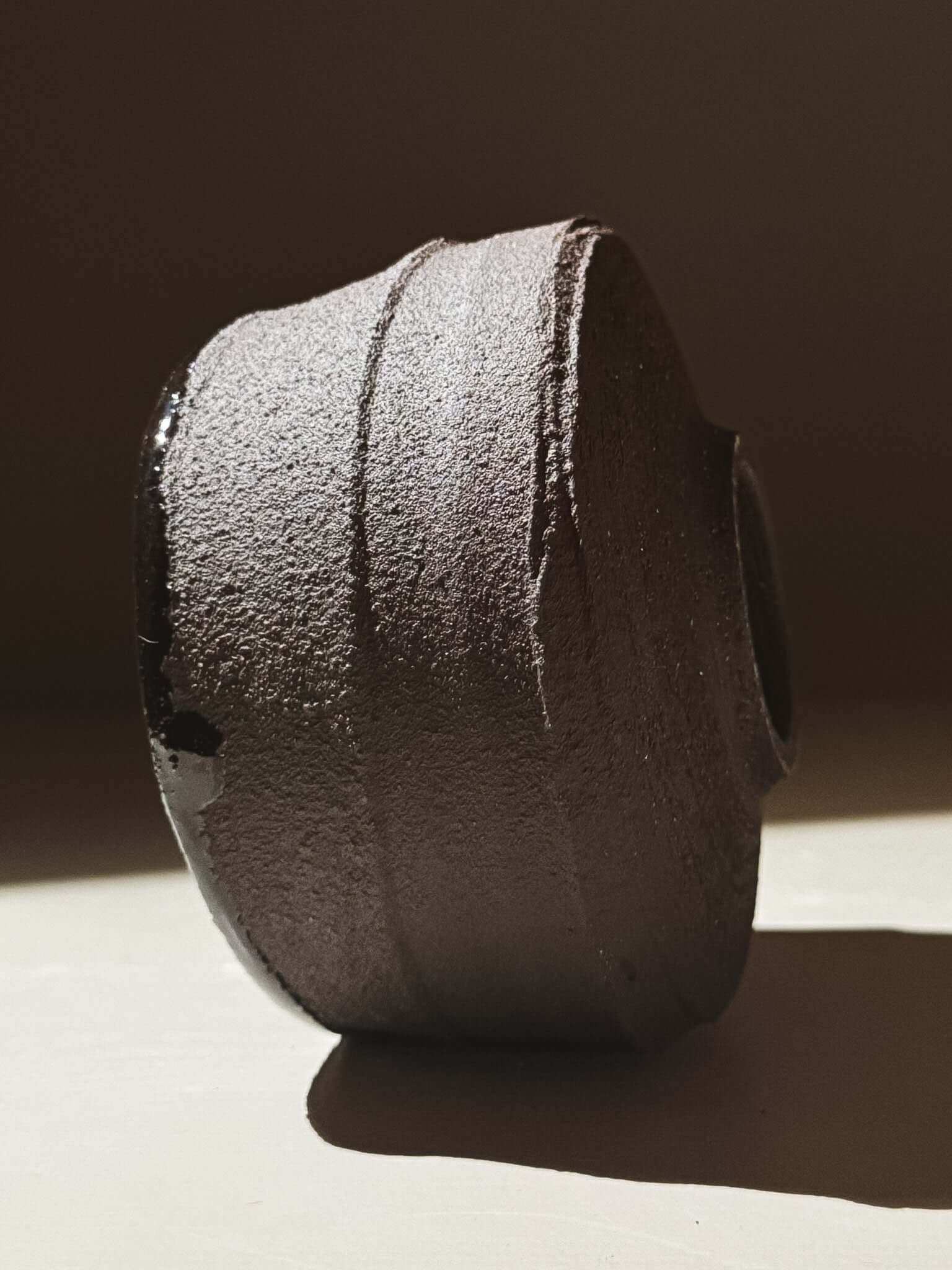 Kuro Matcha Bowl #09 with volcanic stone-inspired textured dark brown slip and glossy dark glaze interior.