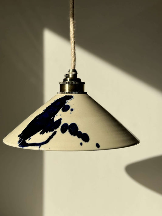 Handmade ceramic lamp shade from the Gosu Series with cobalt blue splashes, highlighting its unique, artistic design.