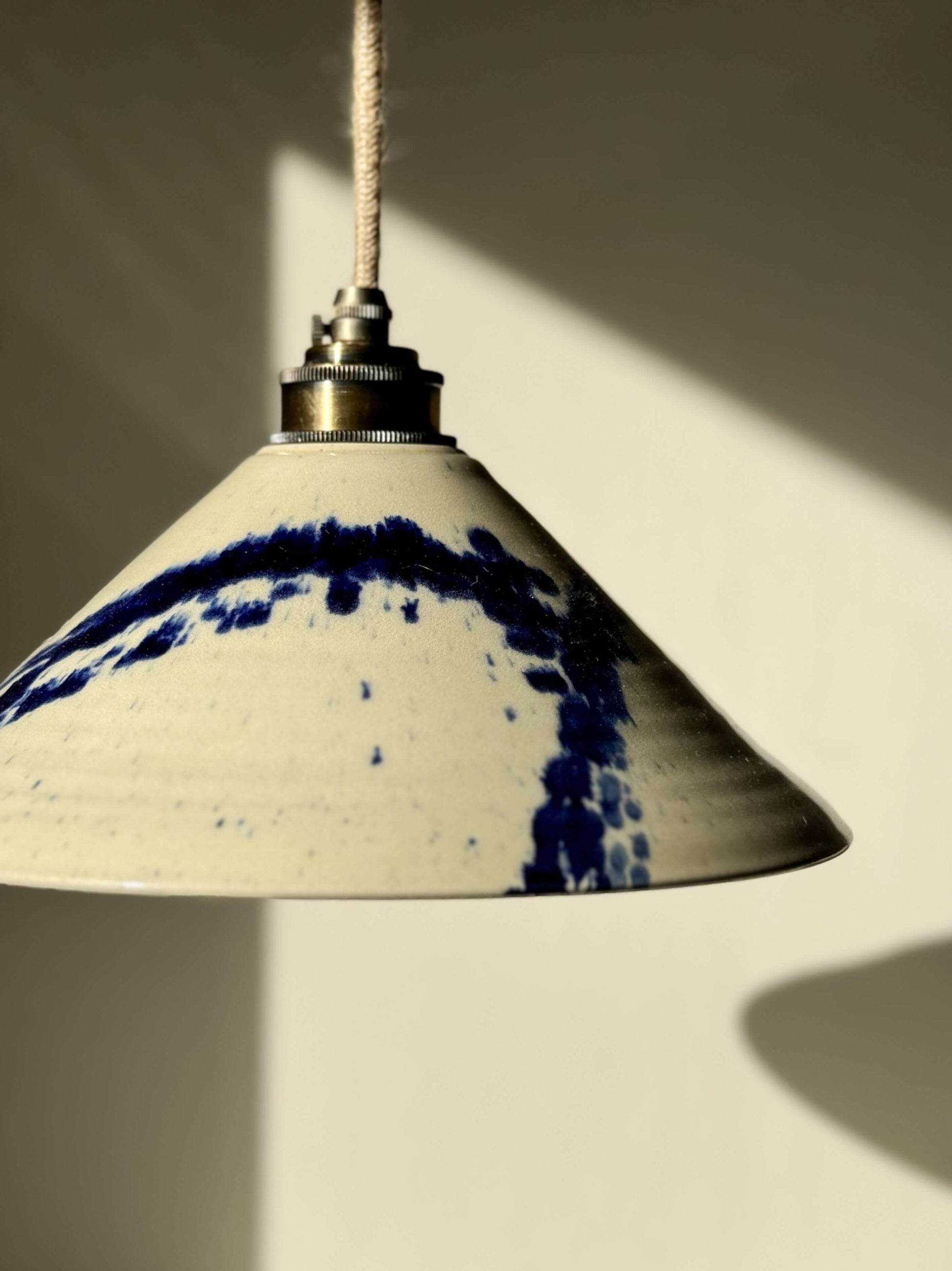 Ceramic lamp shade from Gosu Series with cobalt blue splashes, handmade on a wheel, showcasing unique design and glossy finish.