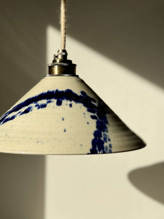 Ceramic lamp shade from Gosu Series with cobalt blue splashes, handmade on a wheel, showcasing unique design and glossy finish.