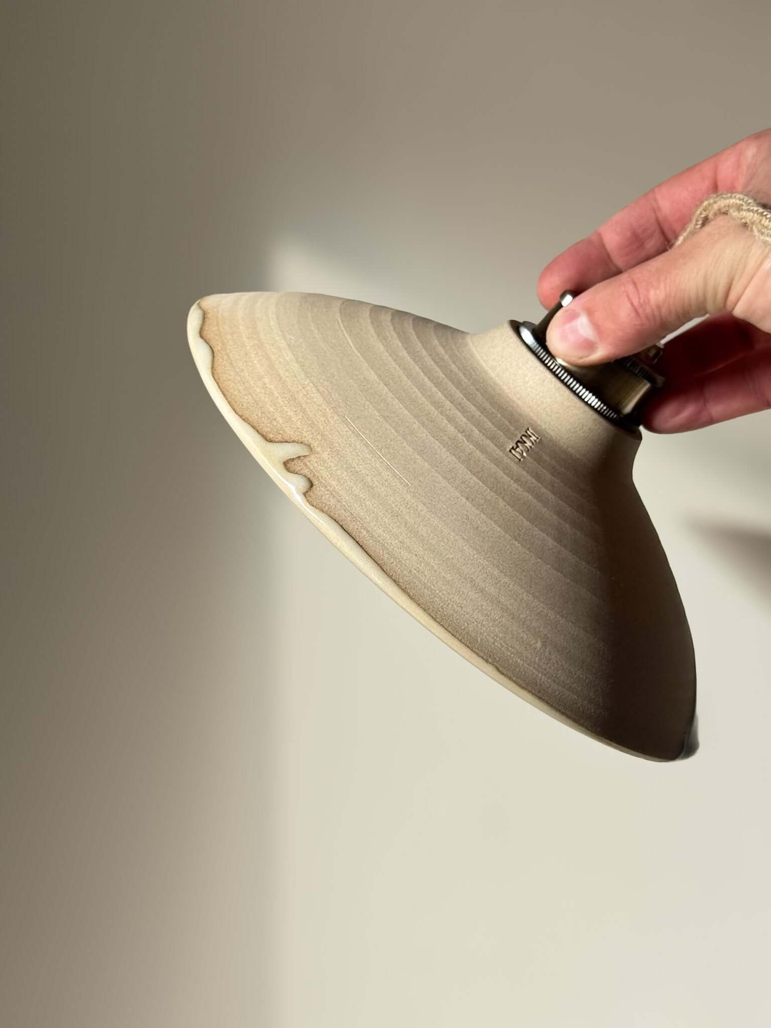 Ceramic Lamp Shade – Mori #02 in hand, showcasing natural tones and raw texture of handmade ceramic design.