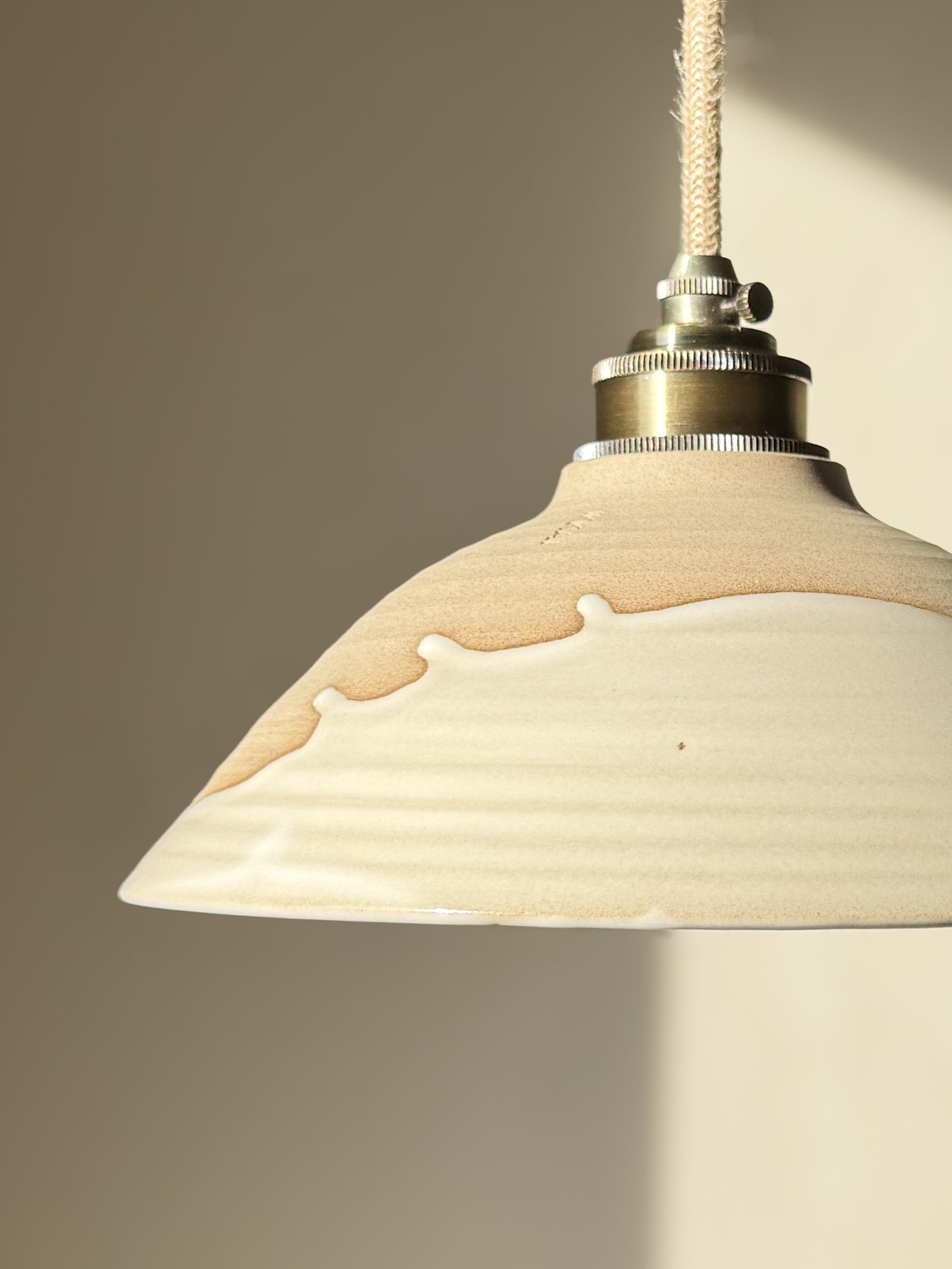 Ceramic Lamp Shade – Yuki #02 with glossy white glaze and raw clay finish, showcasing a calm, snowy softness and elegant slanted profile.