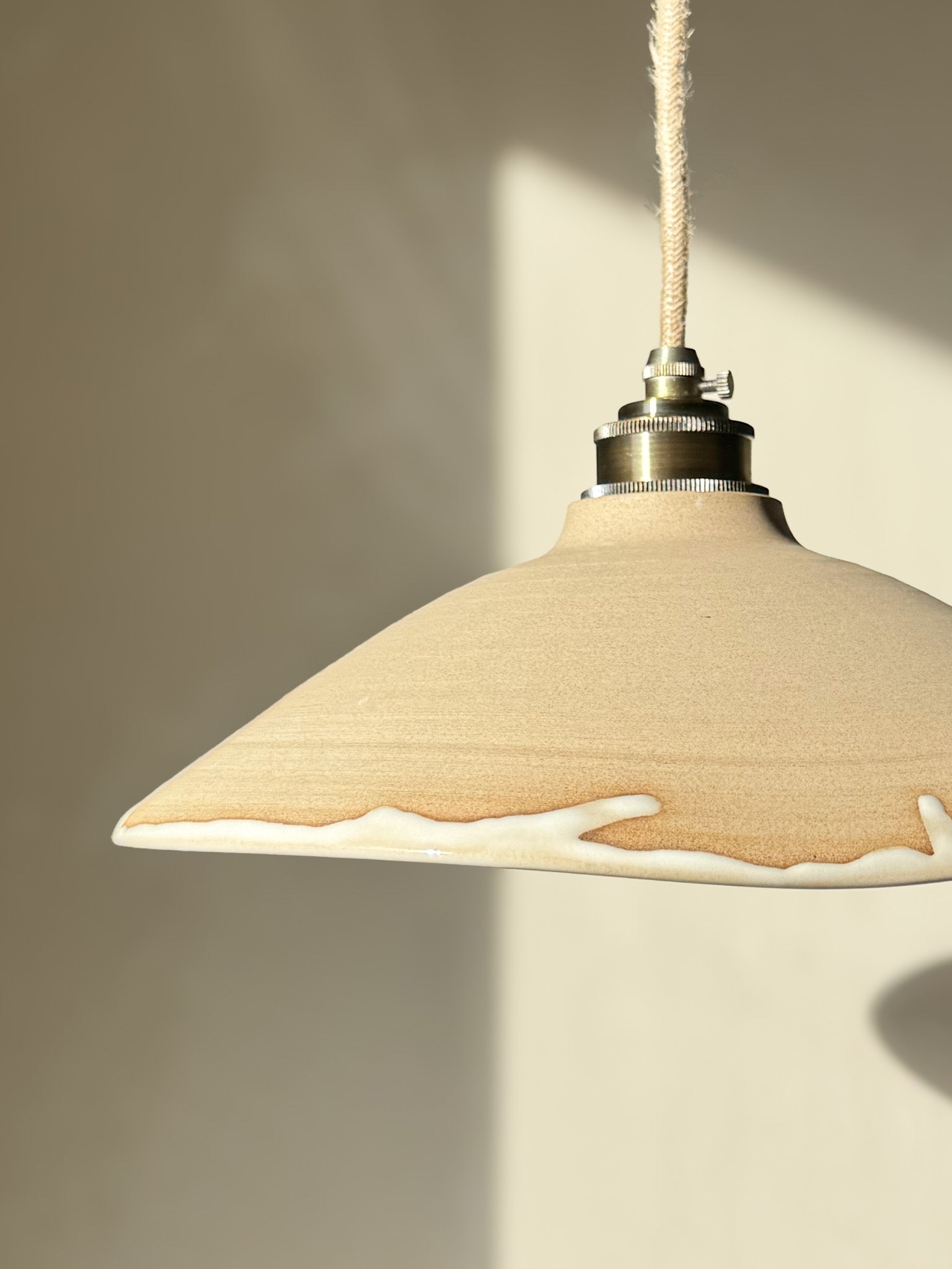 Ceramic Lamp Shade – Yuki #01 with raw clay texture and creamy glaze accent, showcasing a relaxed, organic silhouette.