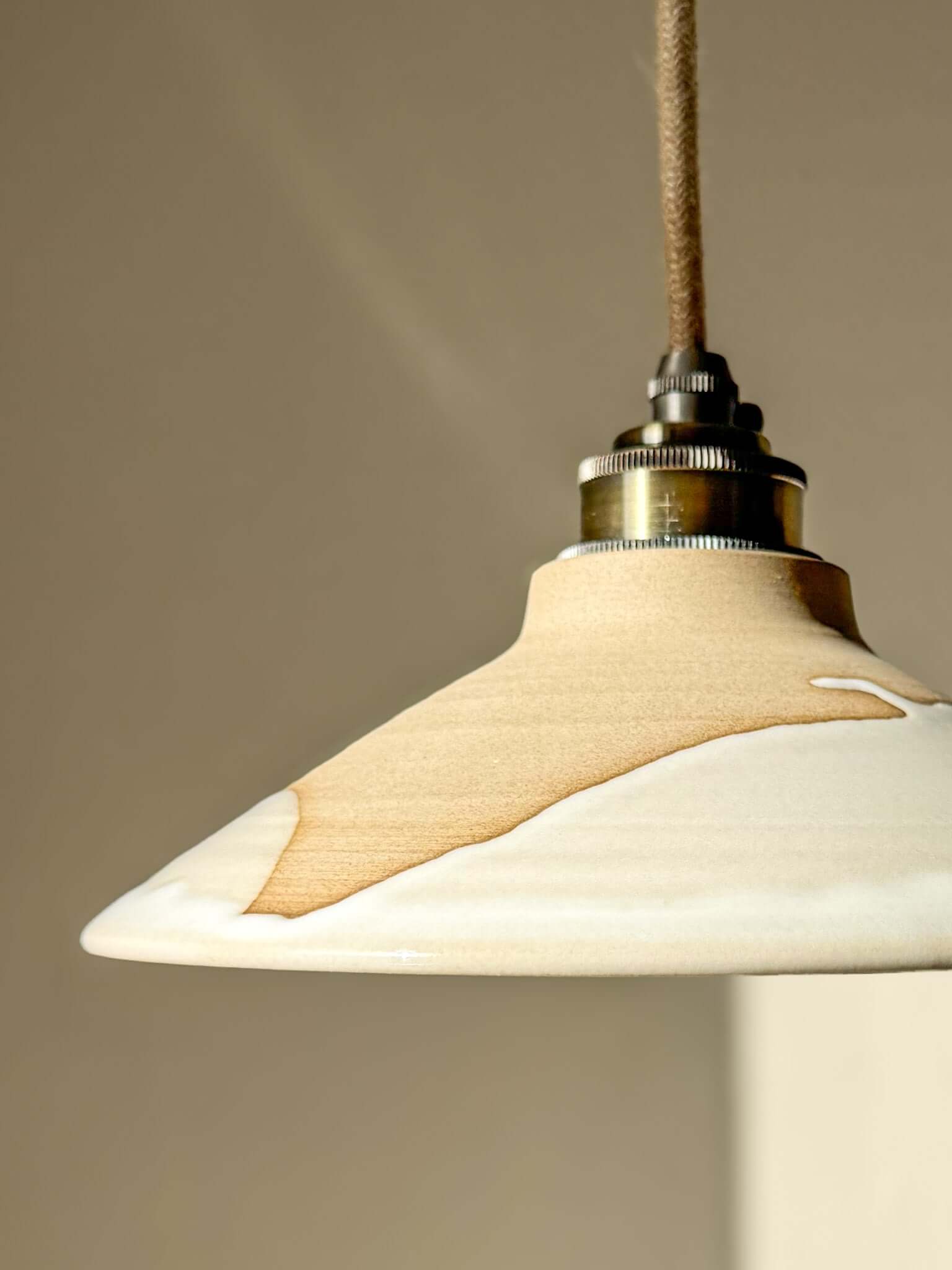 Lamp Shade – Yuki #02 - Custom order in soft snowy tones with a glossy white glaze and raw tactile exterior, hanging decoratively.