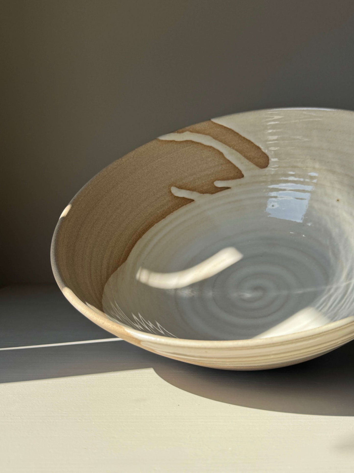 Close-up of handmade ceramic Large Bowl - Yuki with white glaze over clay body, showcasing a harmonious and sculptural design.