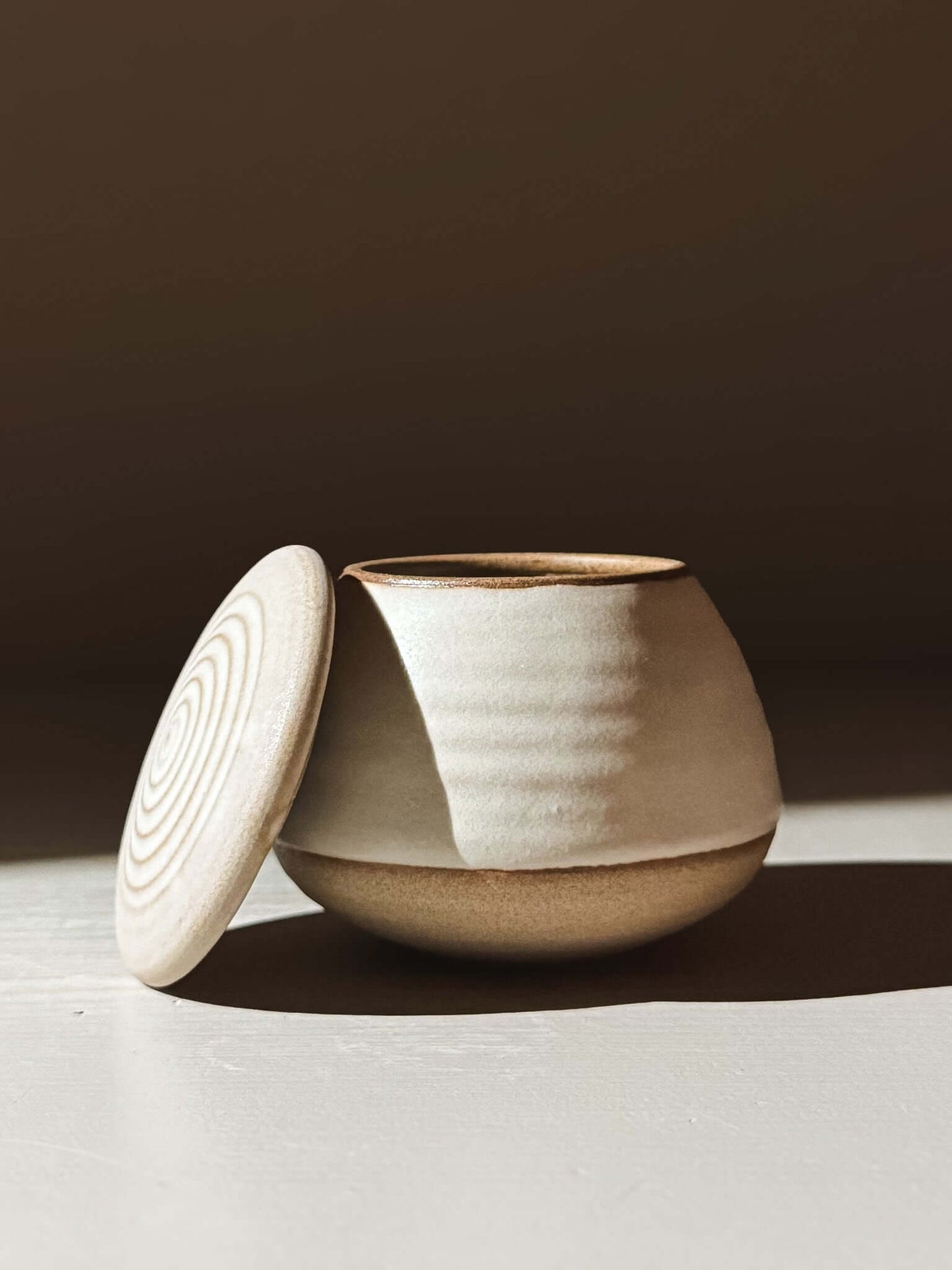 Handmade ceramic Lidded Jar - Eggshell #03 with lid open, showcasing pottery craftsmanship.