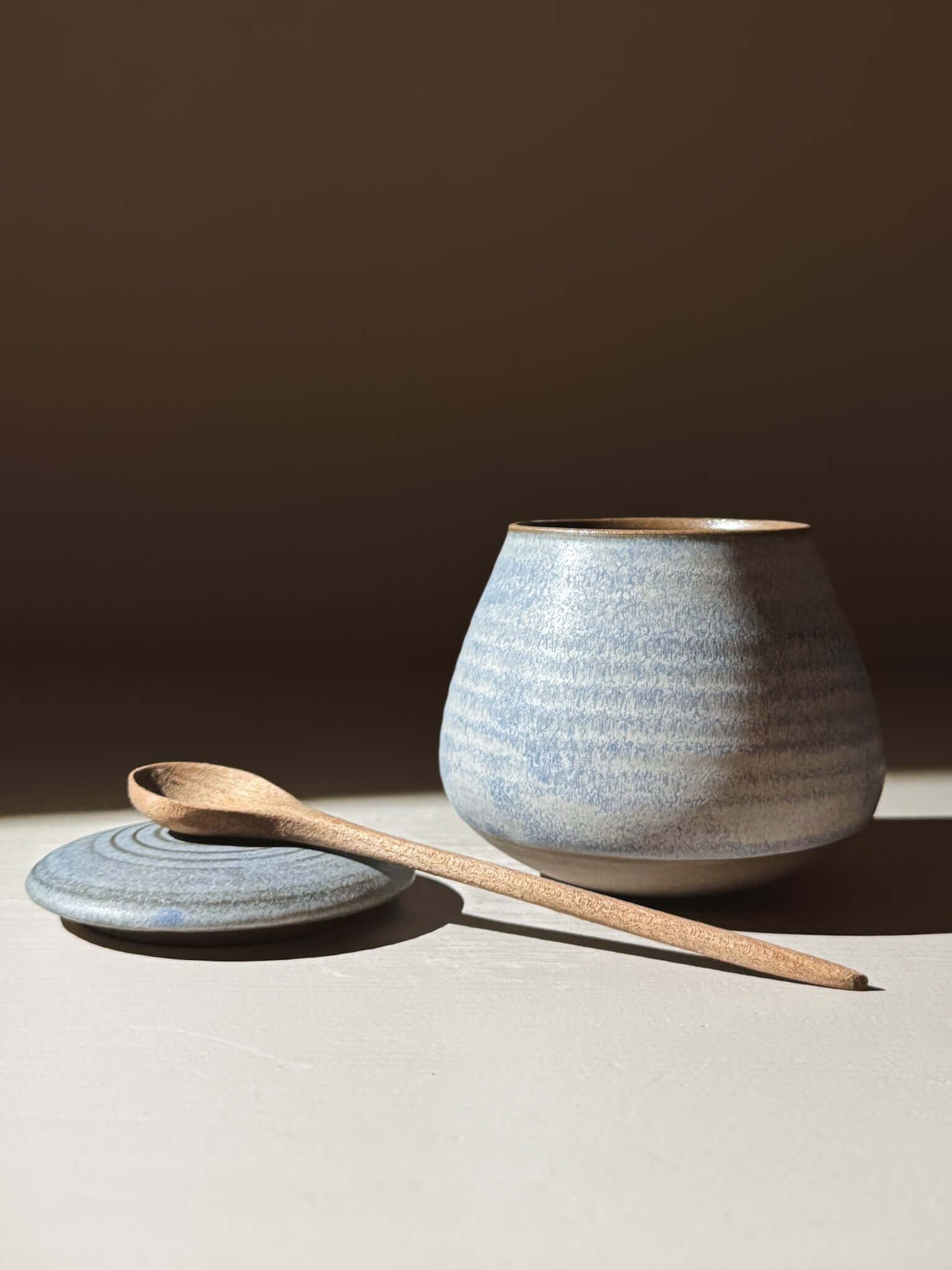 Handmade ceramic Lidded Jar - Mizu #01 with wooden spoon and lid, showcasing artisan pottery craftsmanship.