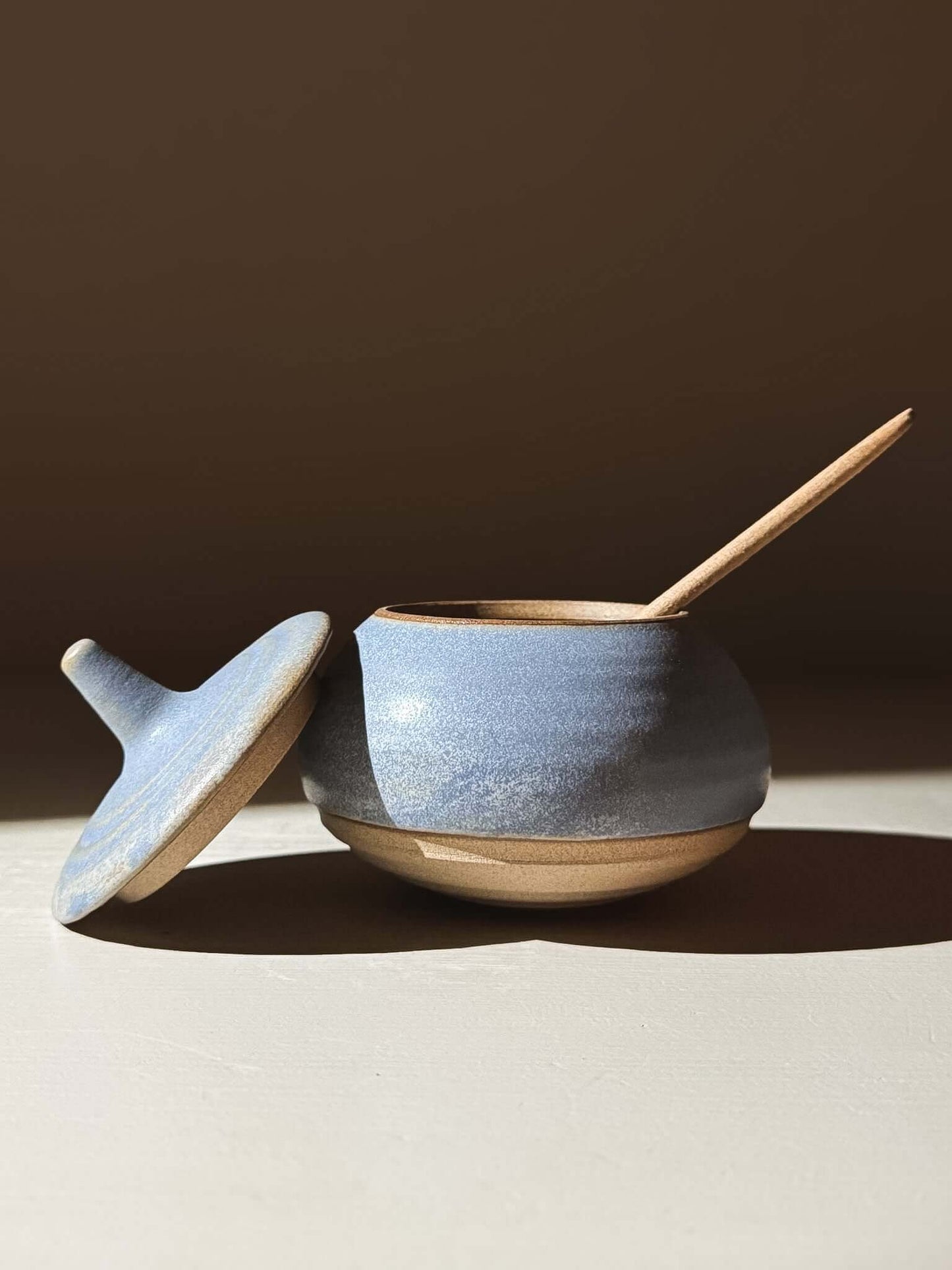 Handmade ceramic Lidded Jar - Mizu #02 with lid and spoon, exemplifying exquisite pottery craftsmanship.