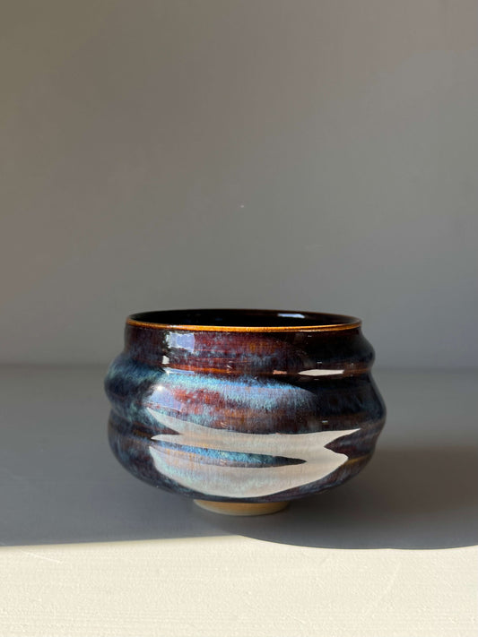 Handmade ceramic Matcha Bowl - Glossy Blue #04 with deep earthy tones and flowing blue patterns, featuring a soft texture and raised foot.