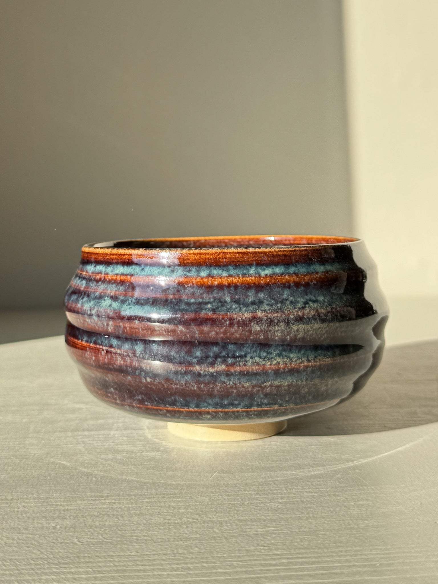 Matcha Bowl - Glossy Blue #02 with deep earthy tones and flowing blues, featuring unique handcrafted design and raised foot.