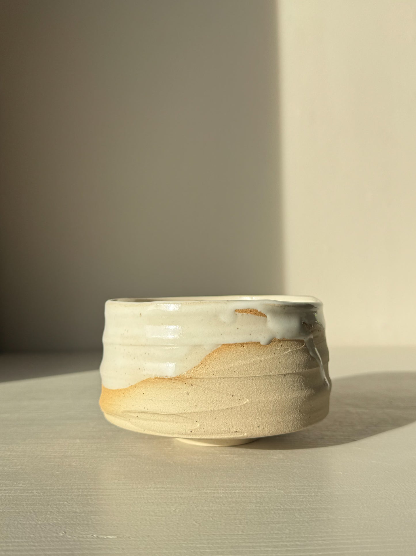Matcha Bowl – Glossy White #05 with speckled stoneware clay and glossy white glaze on a neutral background.