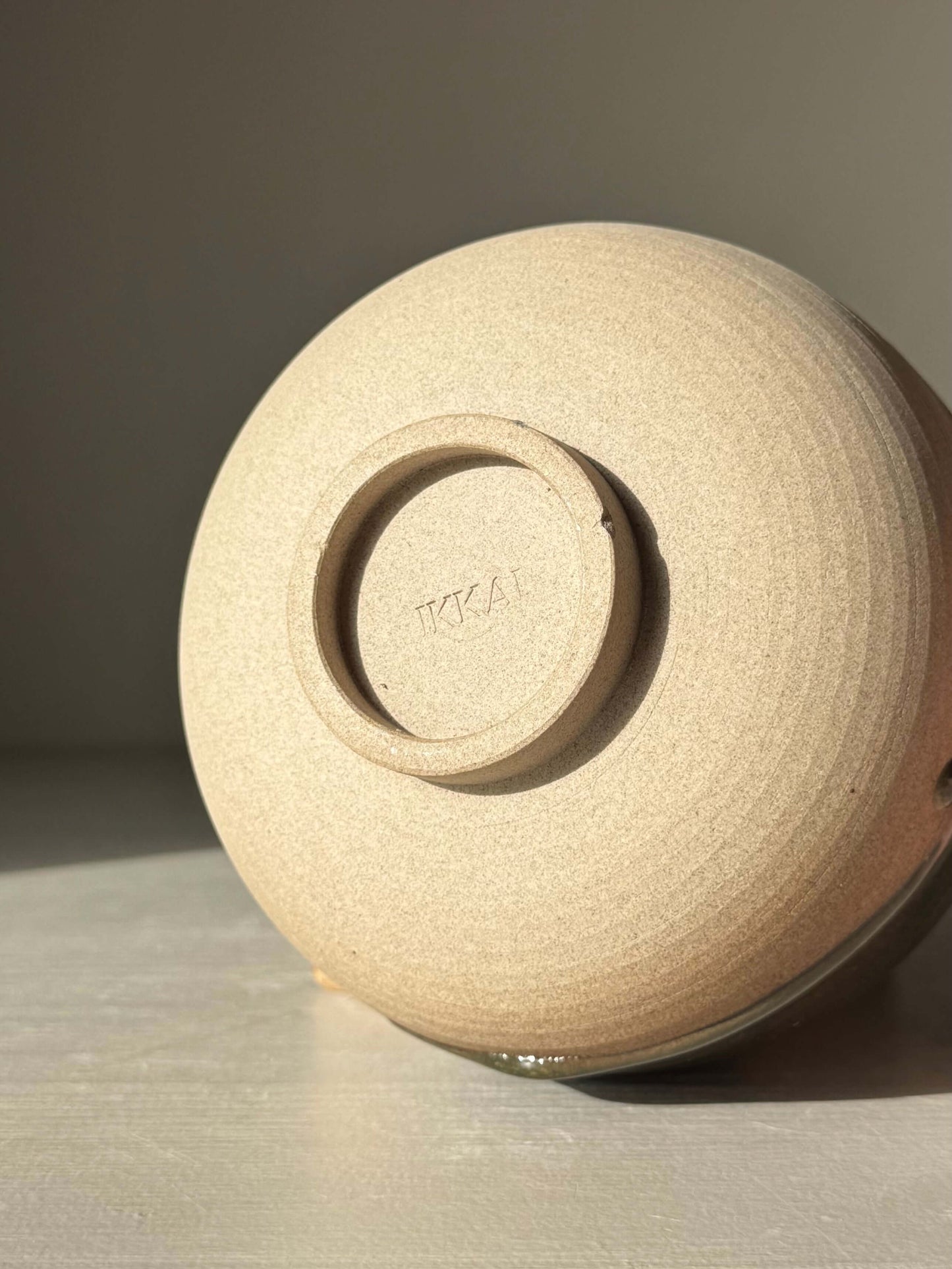 Bottom view of Matcha Bowl – Inyo #04, showcasing the handmade ceramic texture in natural lighting.