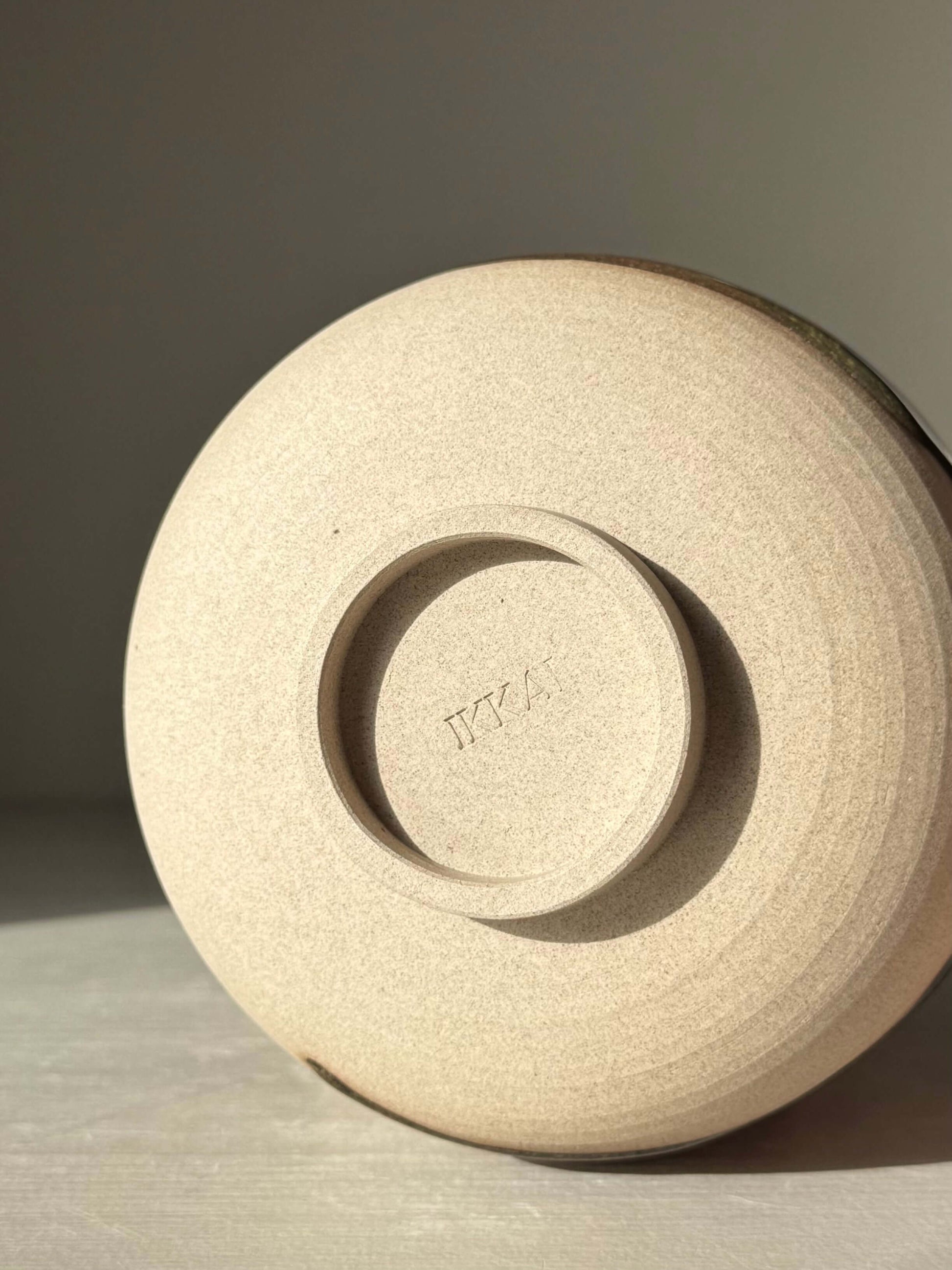 Bottom view of Matcha Bowl – Inyo #03, handmade ceramic bowl showcasing unique glaze work and warm stoneware clay texture.