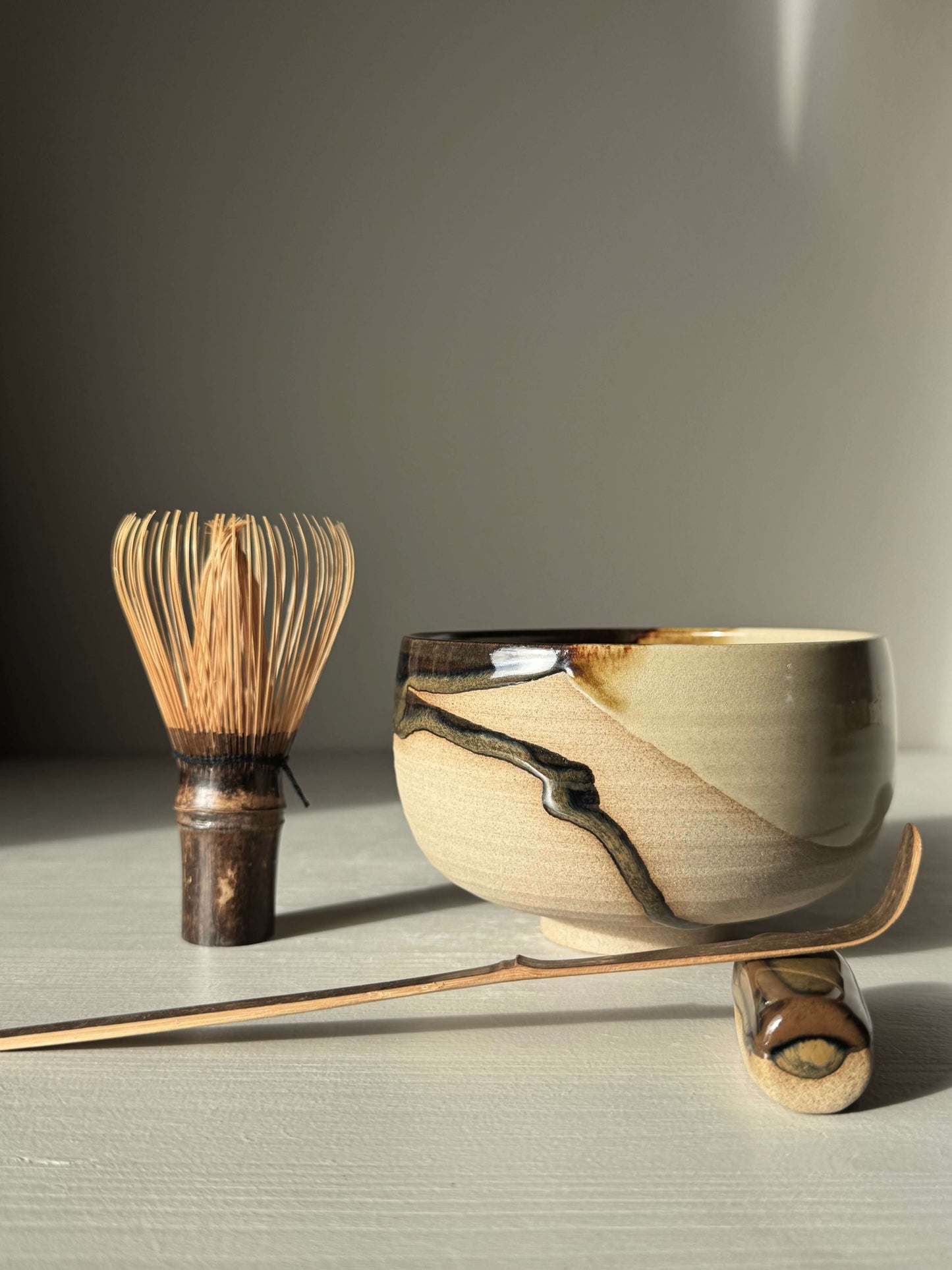 Handmade ceramic Matcha Bowl – Inyo #01 with whisk and scoop on light background