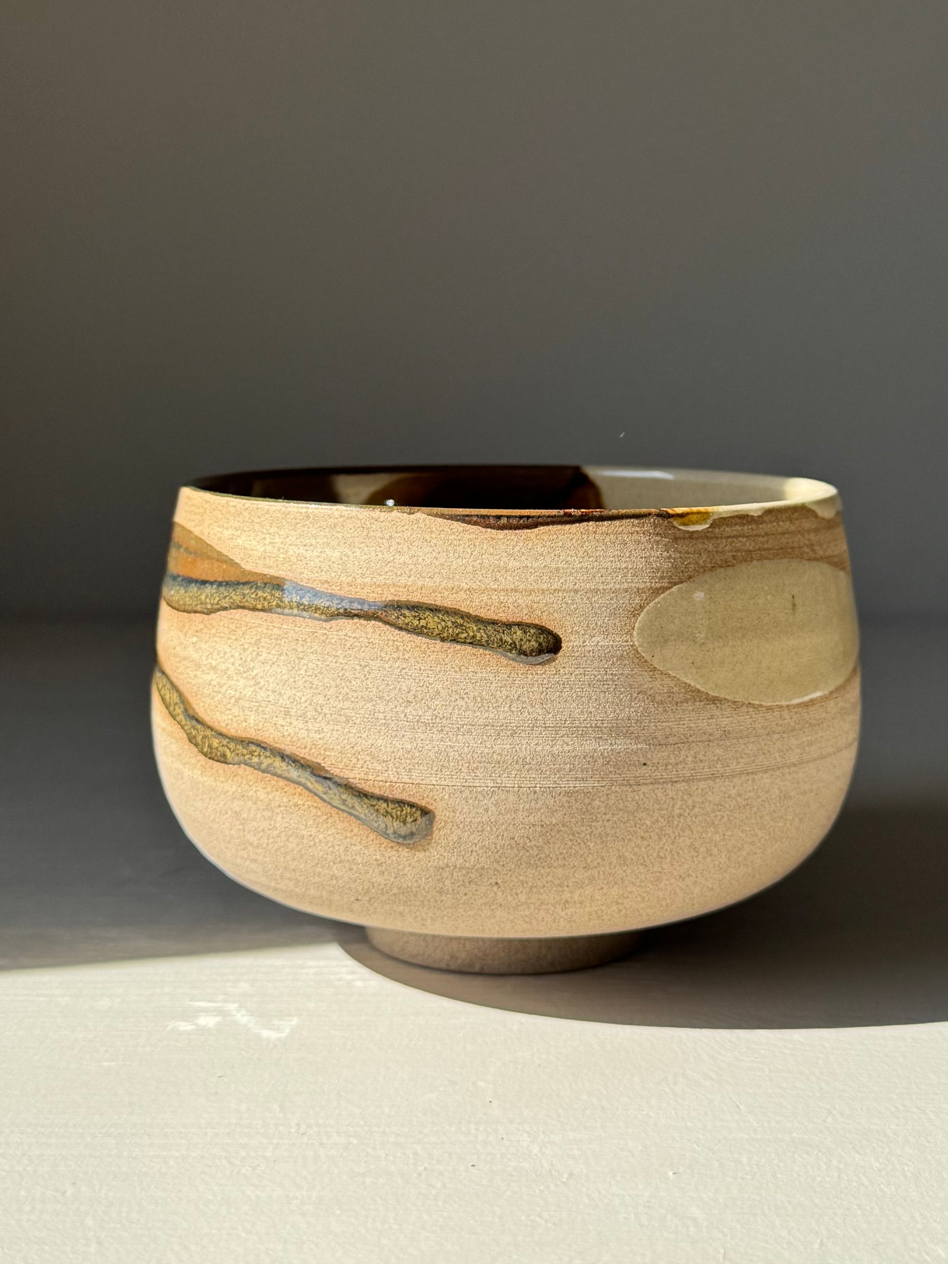 Matcha Bowl – Inyo Series #02, handmade ceramic with tenmoku and clear glaze on stoneware, rounded design.