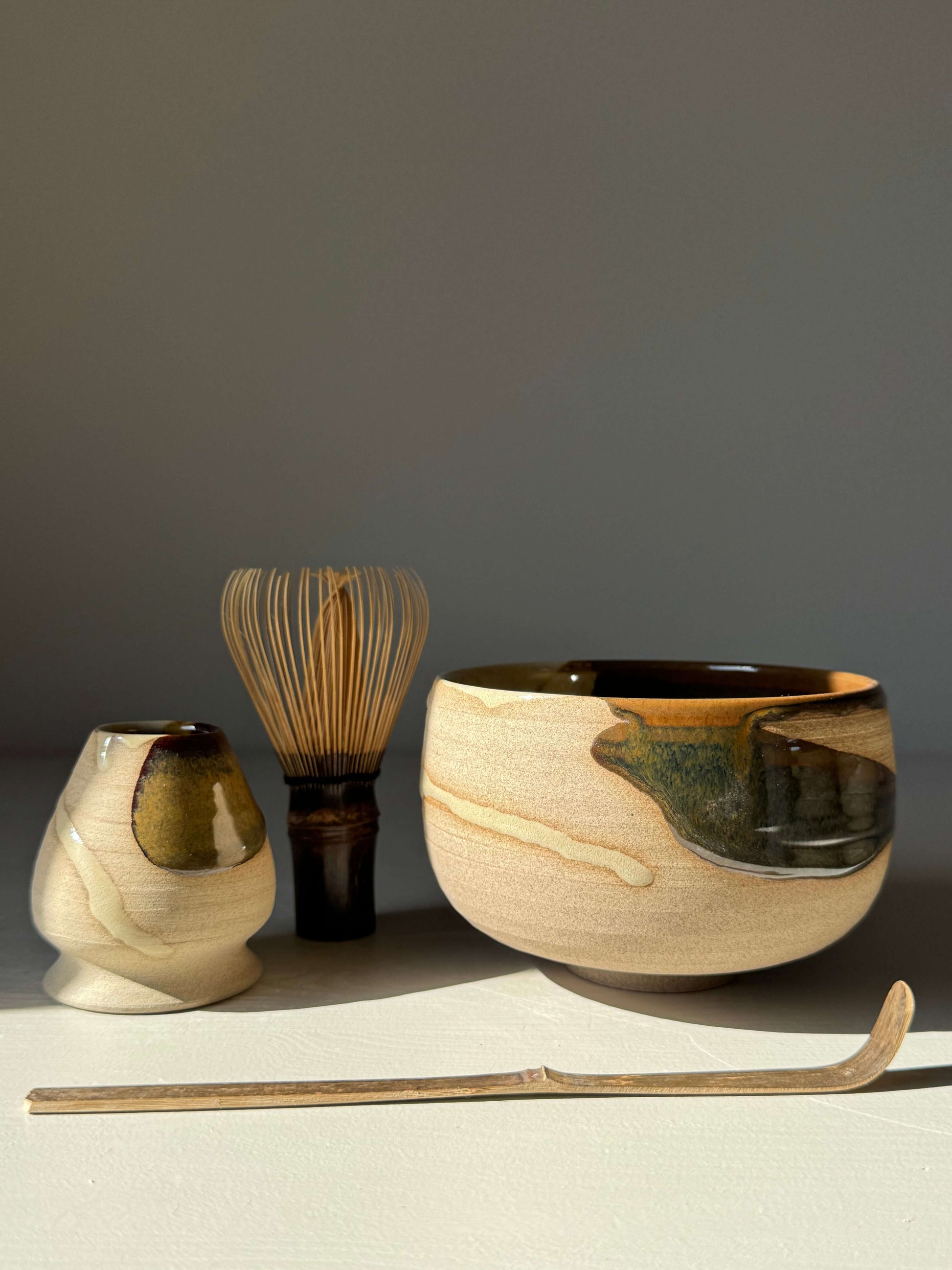 Matcha Bowl – Inyo Series #03 with handmade ceramic glaze, shown with whisk and scoop, highlighting unique design and craftsmanship.