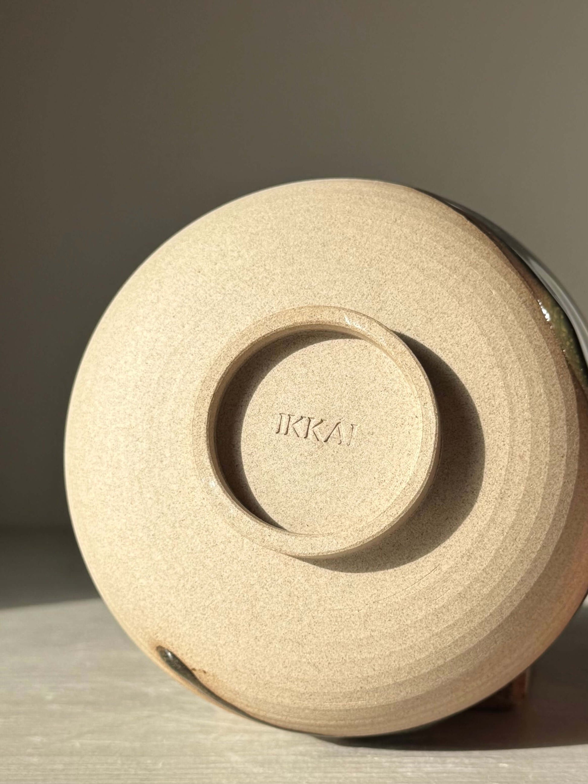 Bottom view of the Matcha Bowl – Inyo #02, showcasing the handmade ceramic design with a distinct maker's mark.