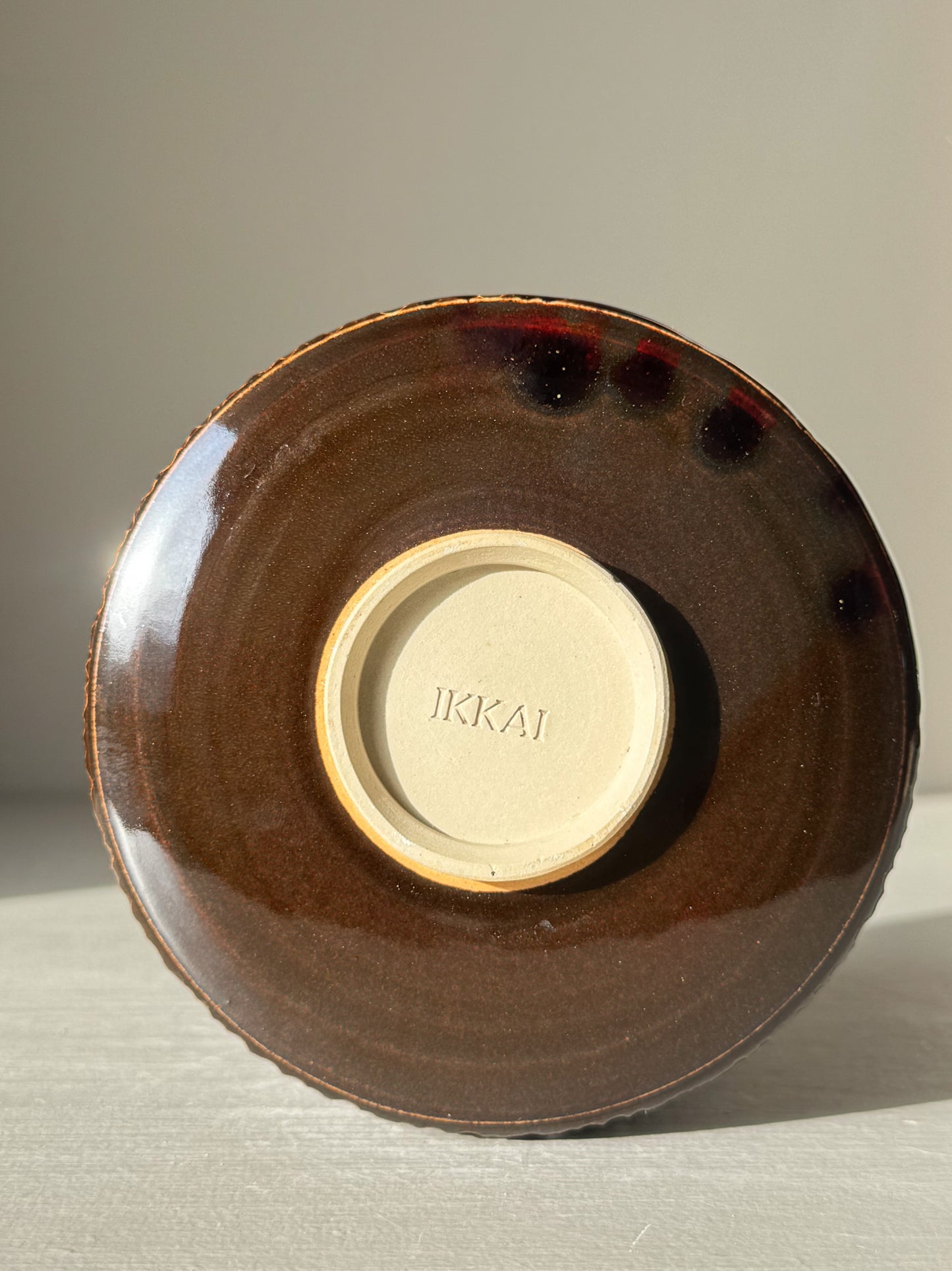 View of the base of Matcha Bowl – Kinsei #01 with rich brown and golden glaze, highlighting its handcrafted design.