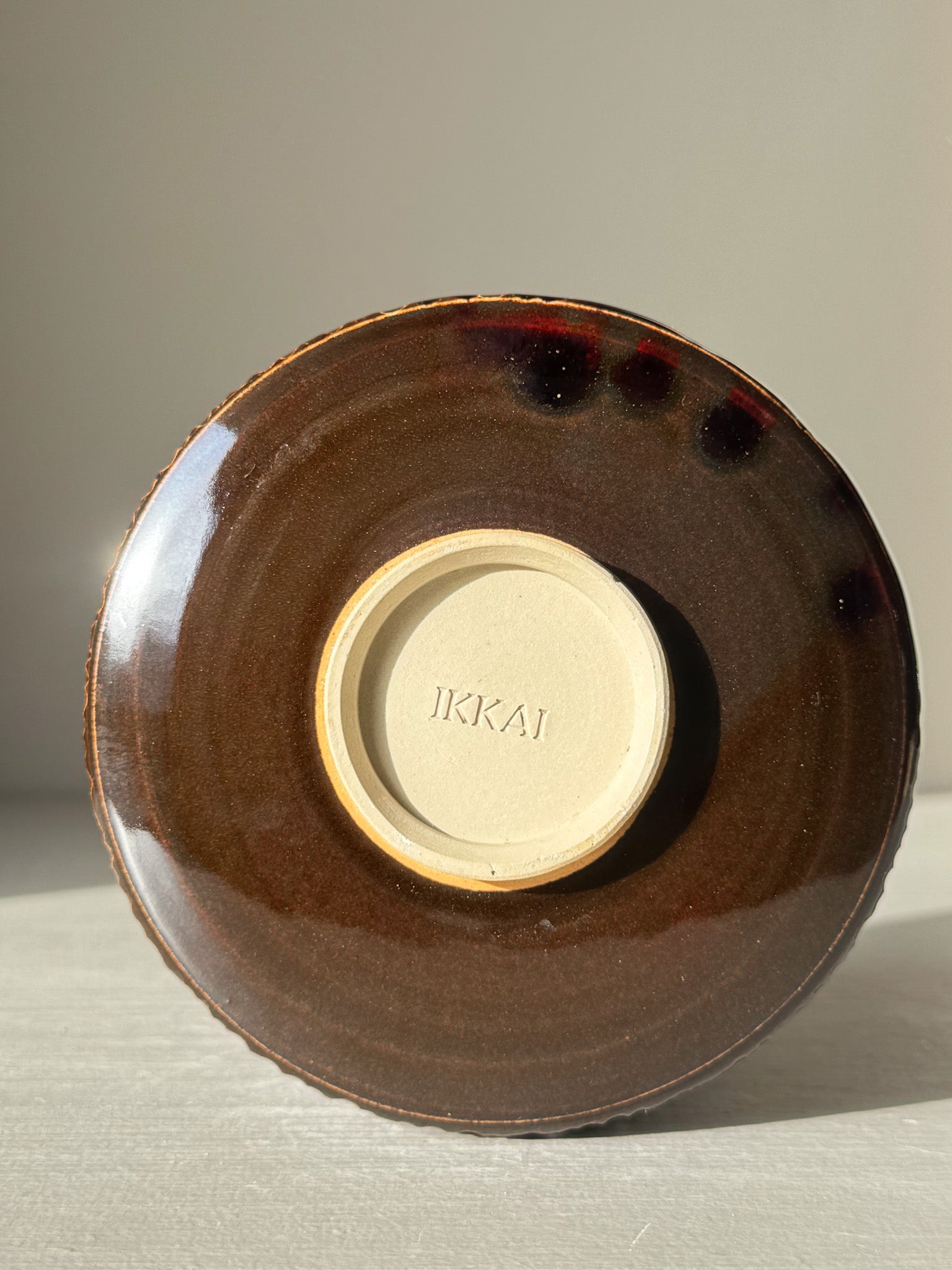 View of the base of Matcha Bowl – Kinsei #01 with rich brown and golden glaze, highlighting its handcrafted design.