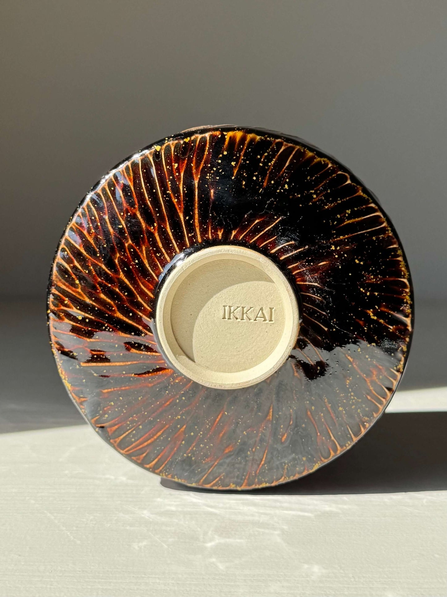 Handmade ceramic Matcha Bowl – Kinsei #01 with rich brown glaze, golden spiral design and Ikai marking on base.