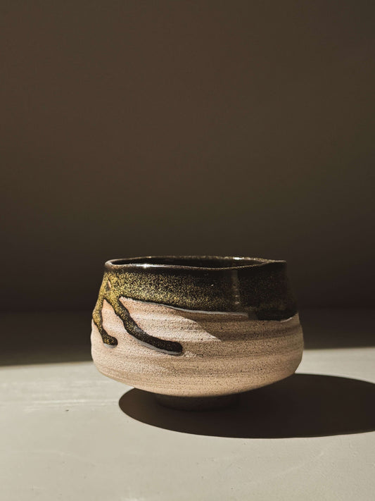 Matcha Bowl – Kuro Ash #03 made of ash-grey stoneware with glossy black glaze showcasing depth and character on a dark background.