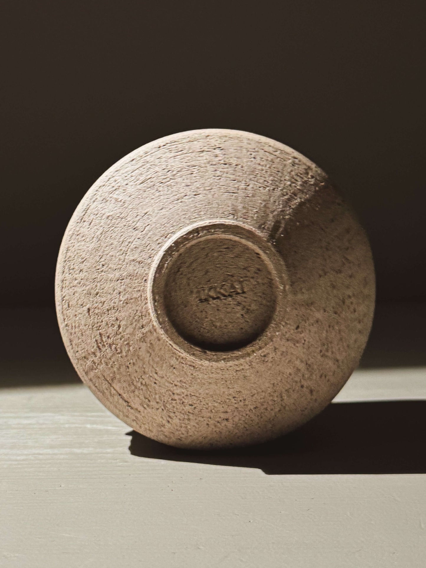 Bottom view of Matcha Bowl – Kuro Ash #02 showing textured stoneware clay