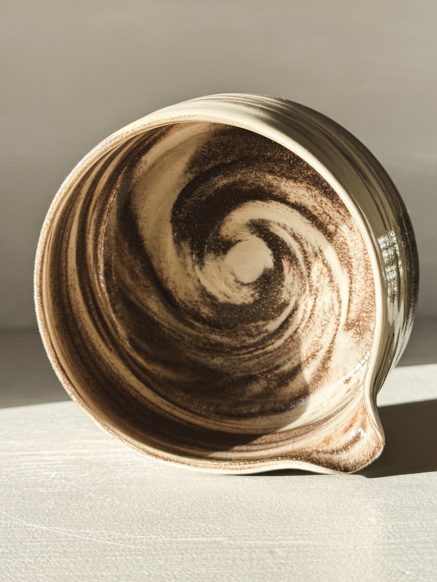 Matcha Bowl Spout - Marbled #01 with natural swirls of black and white stoneware clay, clear glaze finish, rounded shape.