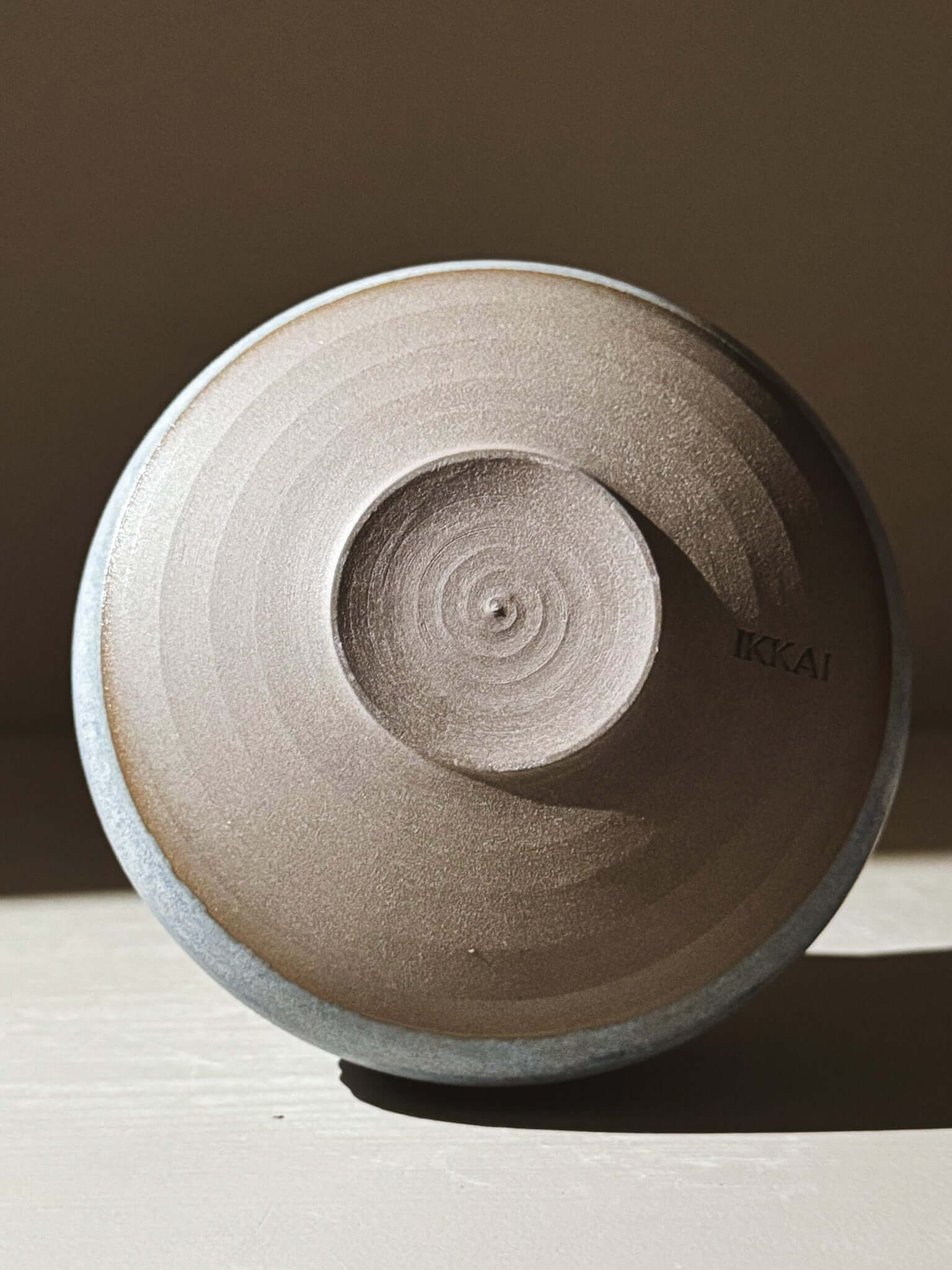Underside view of Matcha Bowl - Mizu #02 showing dark clay foot with matte blue glaze contrast.