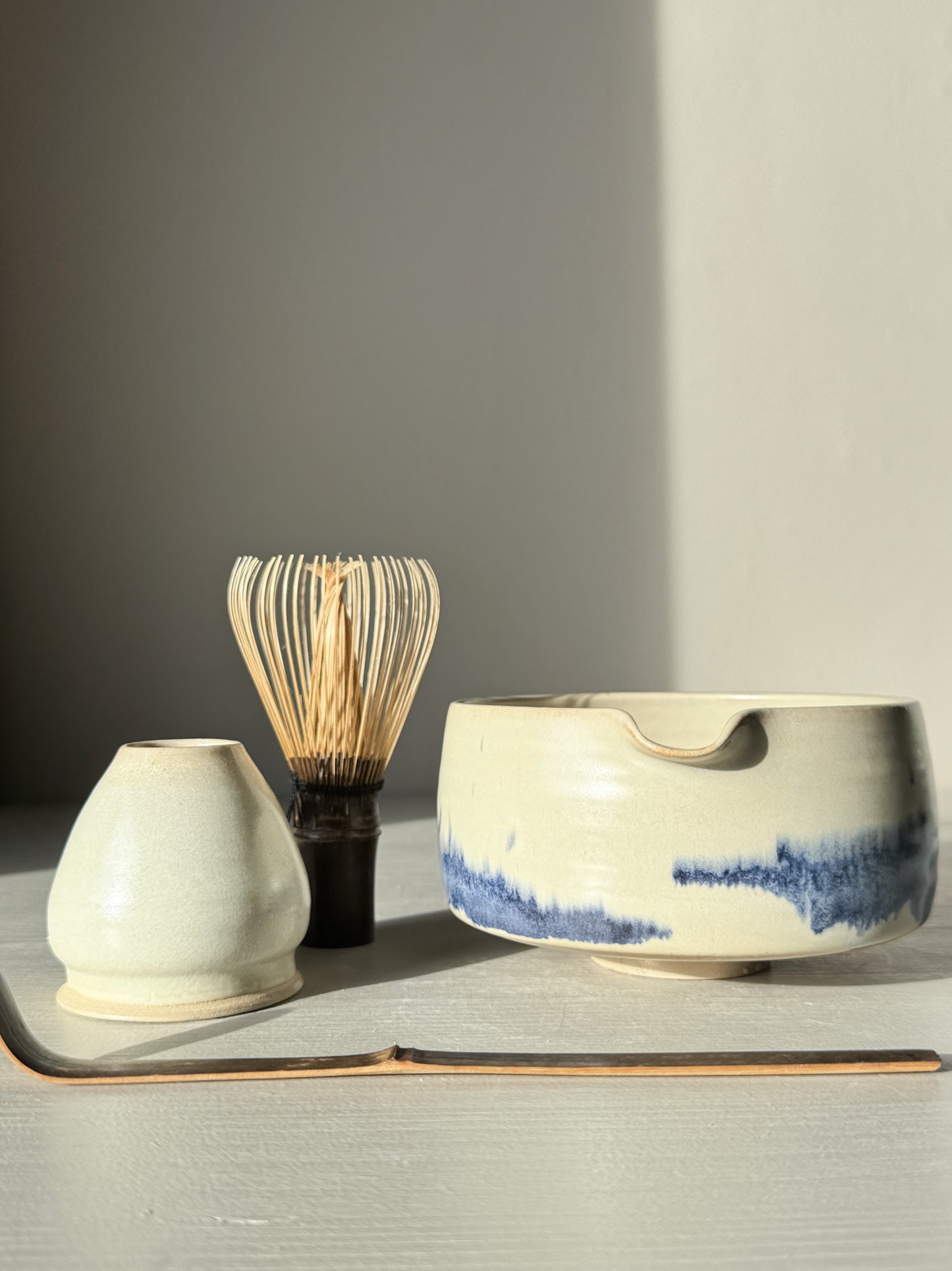 Matcha bowl Spout - Moonstone & Blue #02 with bamboo whisk and tea set on a light background