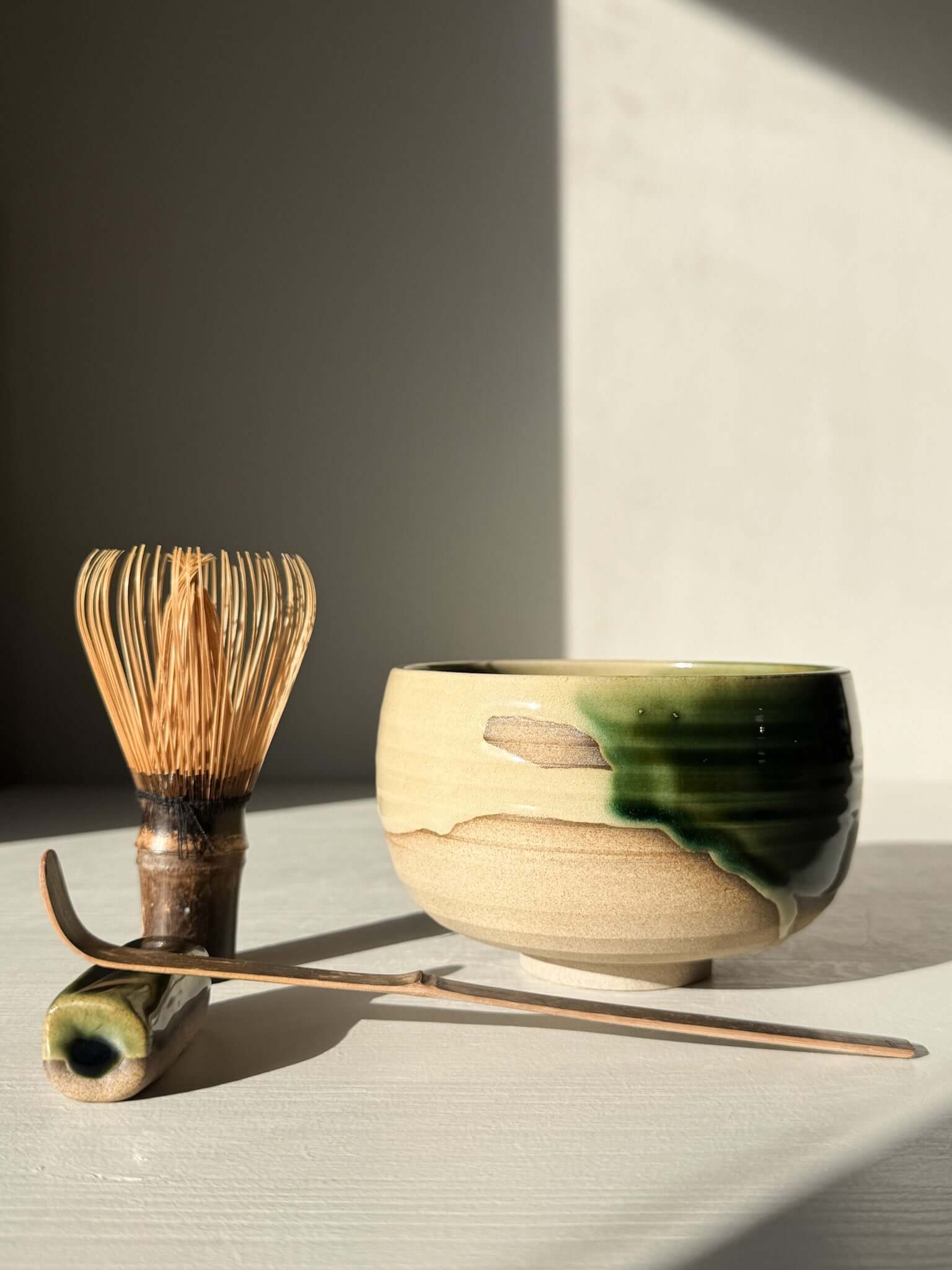 Handmade ceramic Matcha Bowl – Mori #04 with whisk and scoop, featuring organic green and brown glazes, part of the Mori Series.