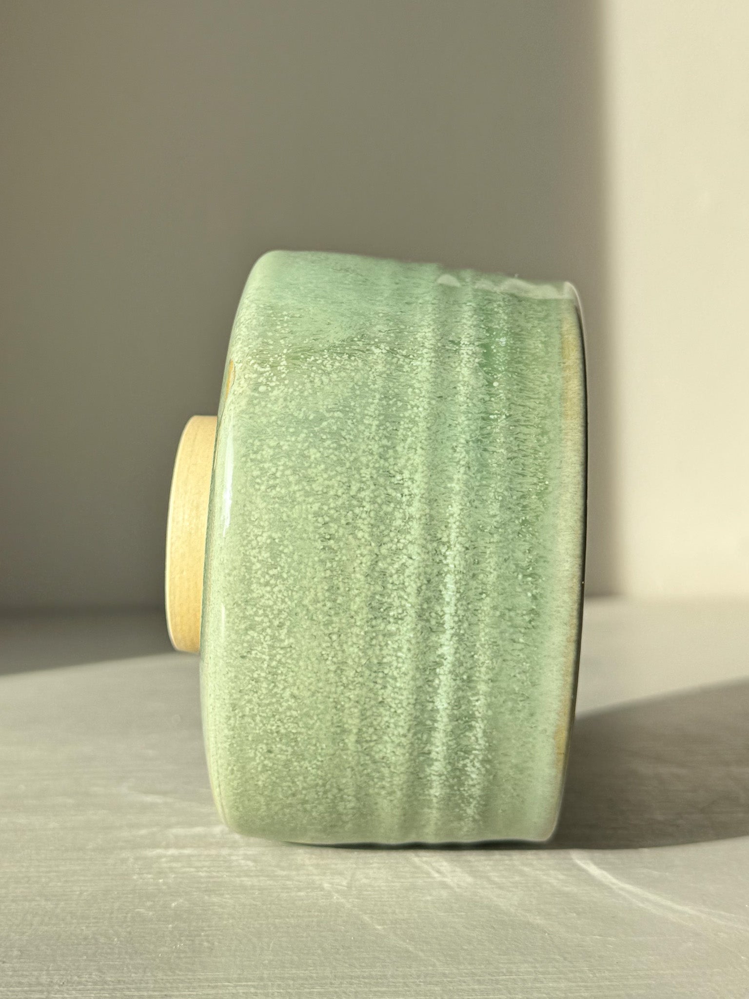 Side view of Matcha Bowl – Sage Glaze #01 showcasing the glossy sage-green finish.