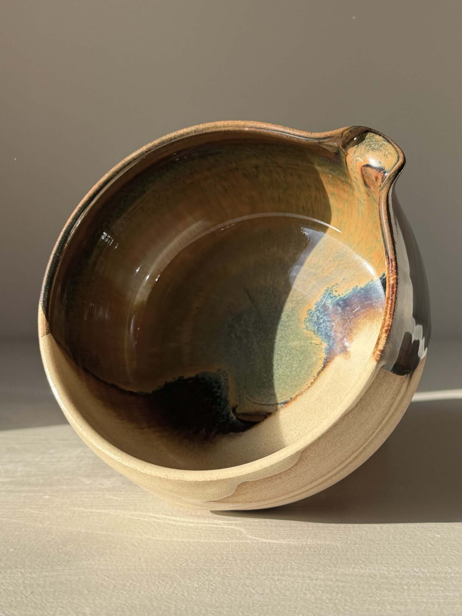 Handmade ceramic Matcha Bowl with Spout – Inyo #04 featuring dark glossy tenmoku and soft clear glaze on stoneware clay.