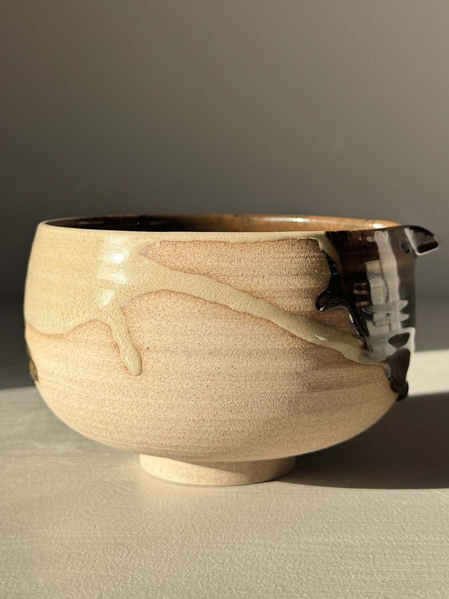 Matcha Bowl with Spout – Inyo #05, handmade ceramic with tenmoku and clear glazes on stoneware clay.