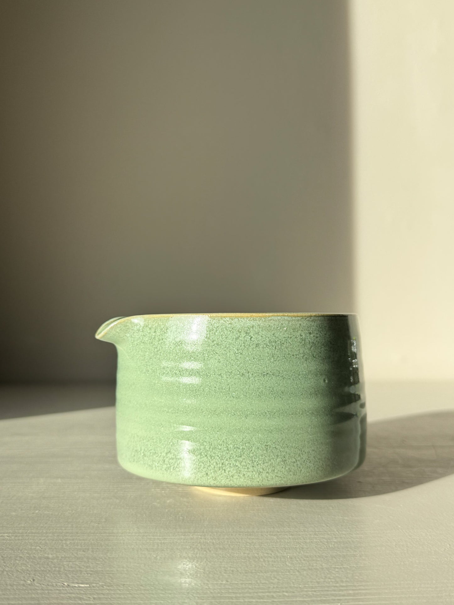 Handcrafted Matcha Bowl Spout – Sage #02 with soft sage-green glaze, perfect for whisking matcha, illuminated in sunlight.