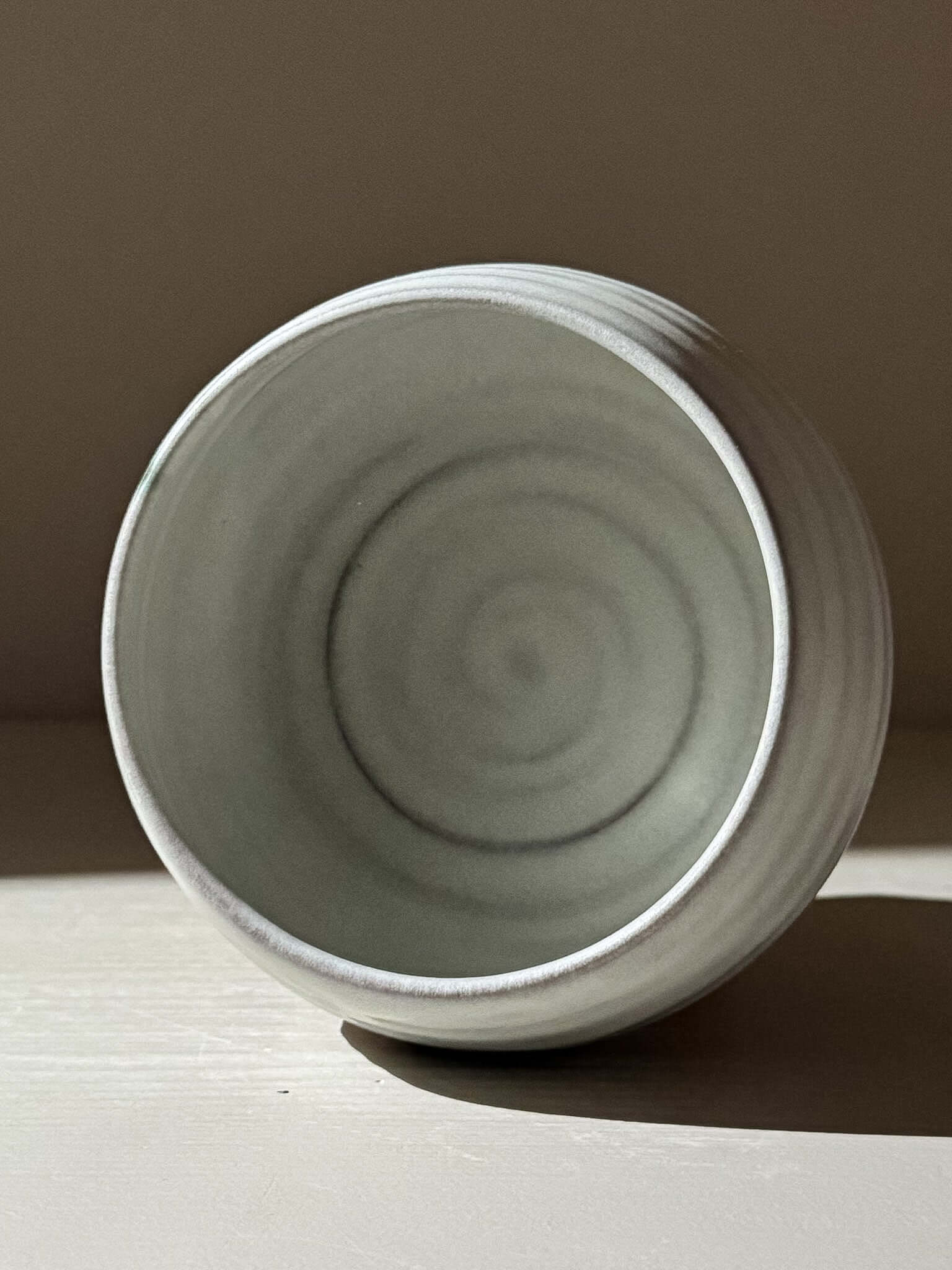 Matcha Bowl - Tsuki #02, dark grey stoneware with white glaze and moonlit tones, hinting pale blue, soft grey, and white in light.