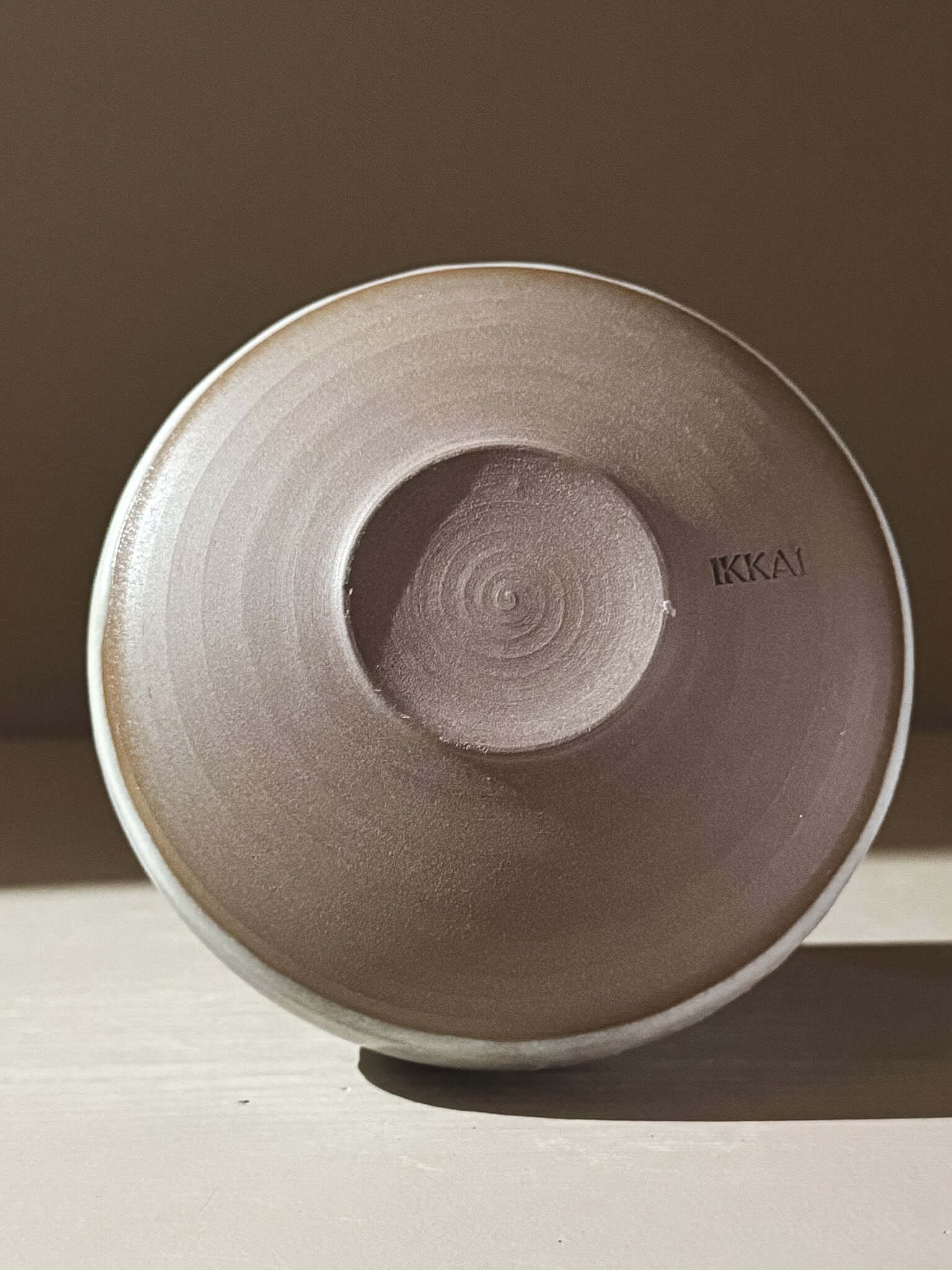 Bottom view of Matcha Bowl - Tsuki #04, showing dark grey stoneware clay and delicate moonlit tones.