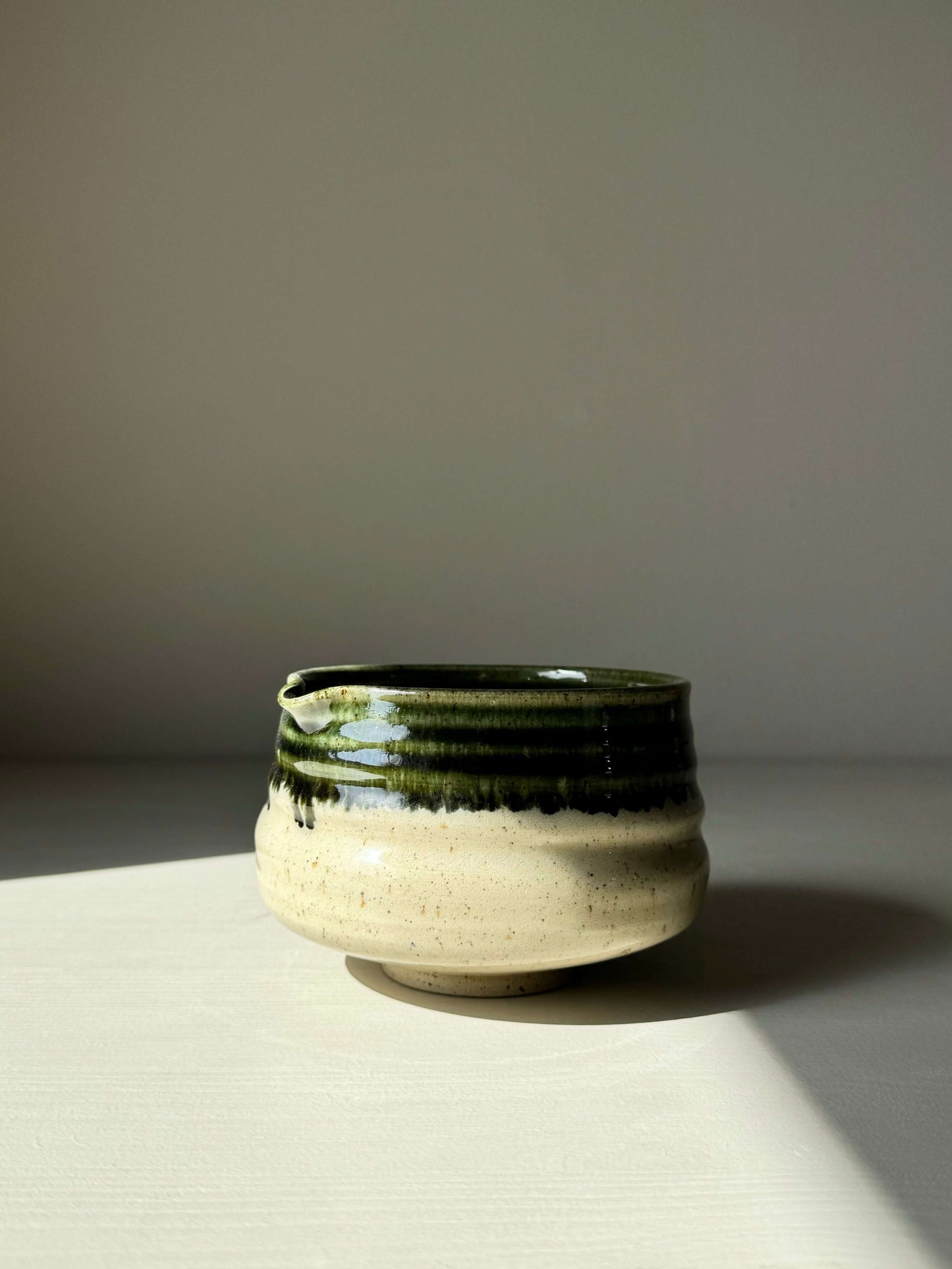 Matcha Bowl with Spout - Green Rim, handmade ceramic with glossy glaze and subtle ridges, designed for easy whisking.