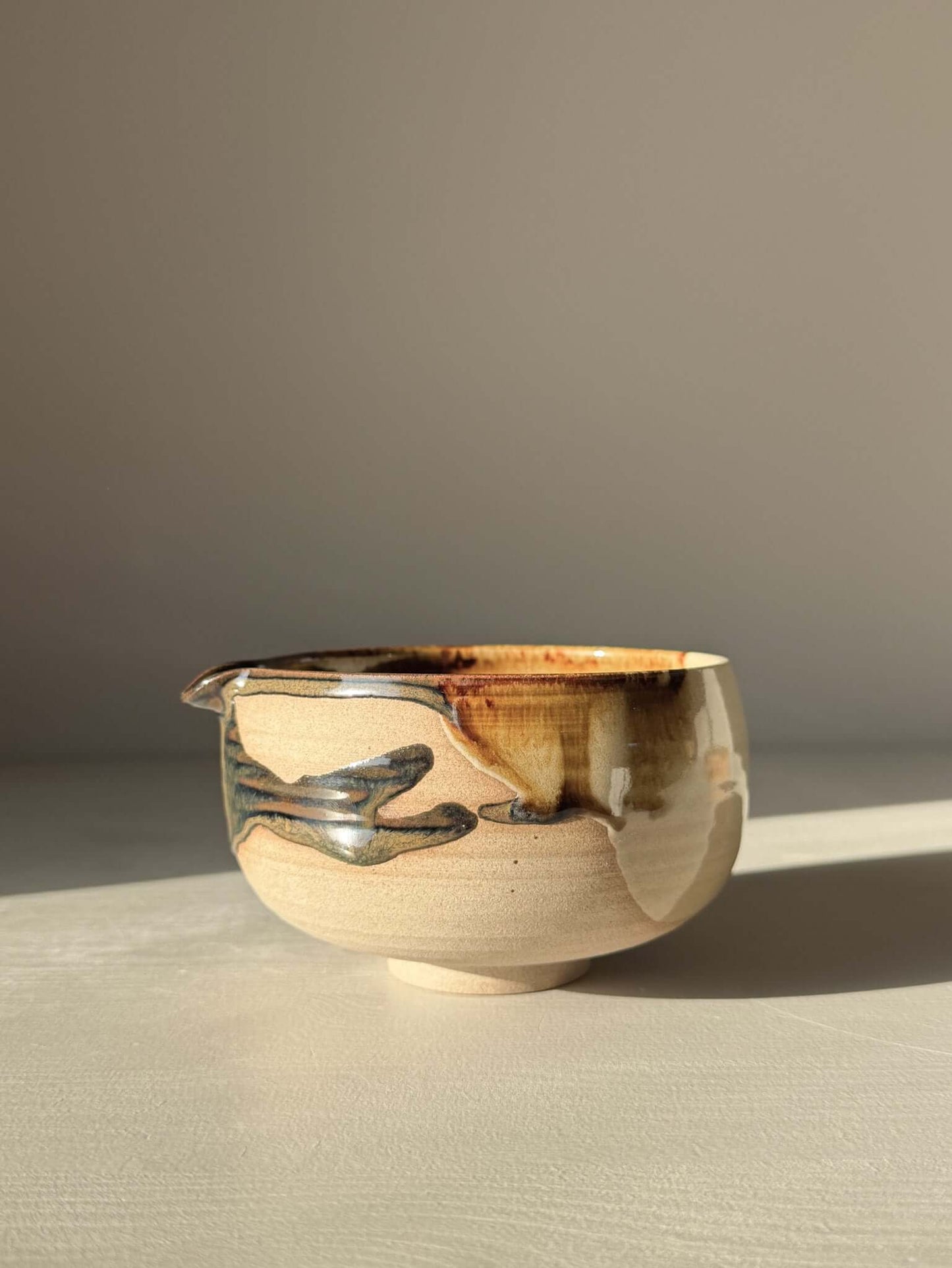 Handmade ceramic Matcha Bowl with Spout – Inyo #06 featuring unique tenmoku and clear glazes on stoneware clay.