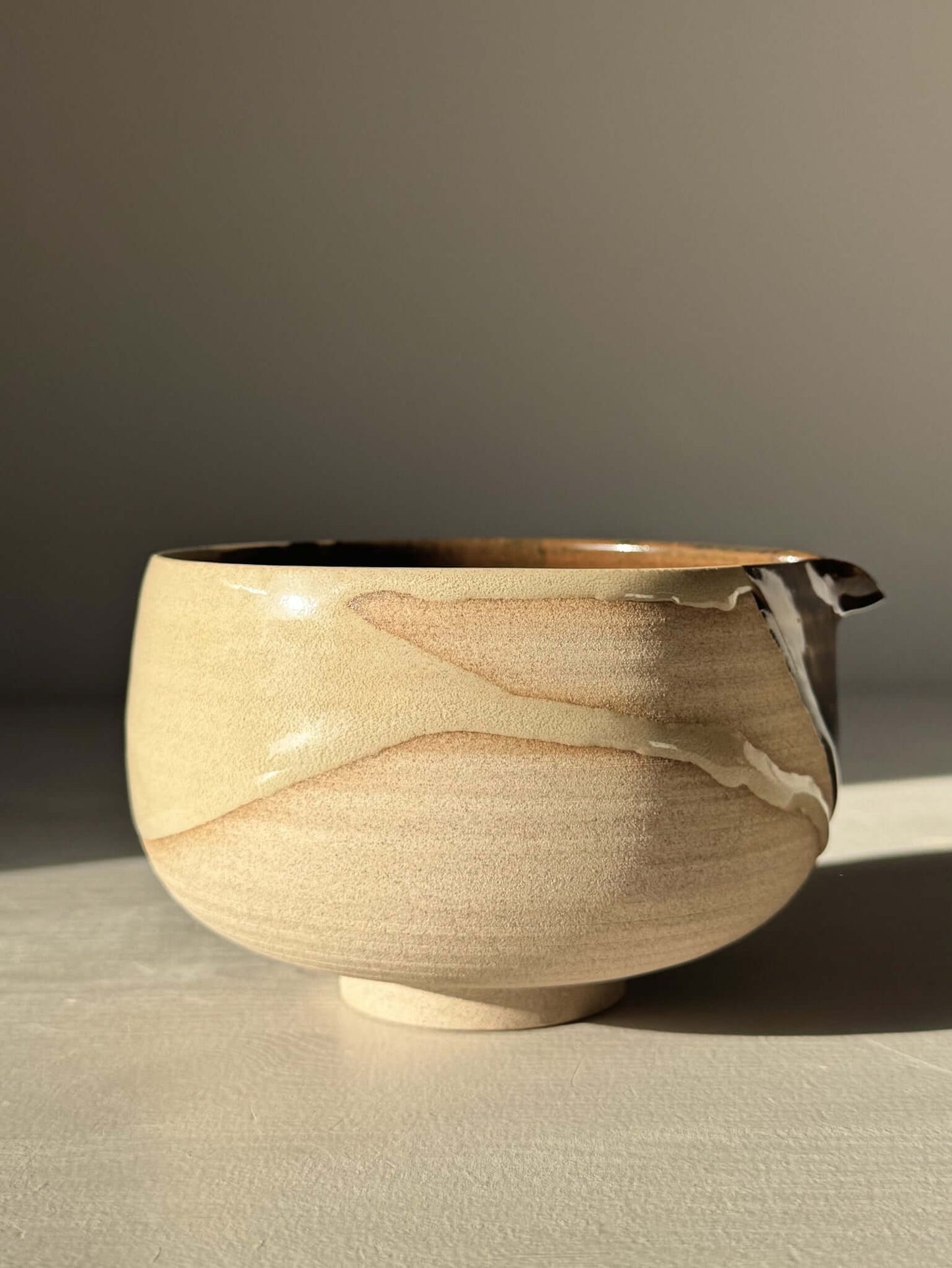 Handmade ceramic Matcha Bowl with Spout – Inyo #03 featuring tenmoku and clear glaze on stoneware clay.