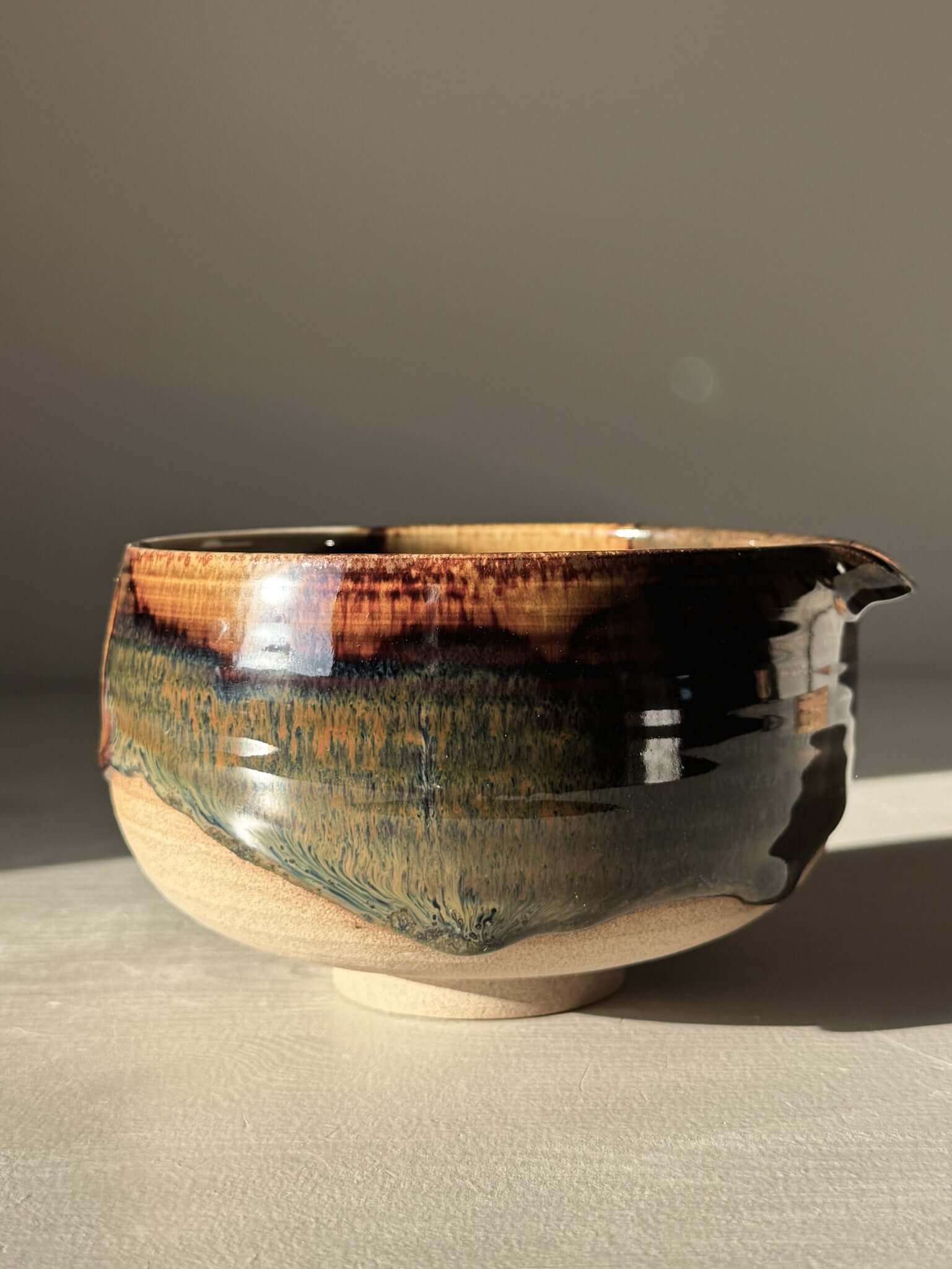 Handmade ceramic Matcha Bowl with Spout – Inyo #06 featuring tenmoku and clear glazes on stoneware clay.
